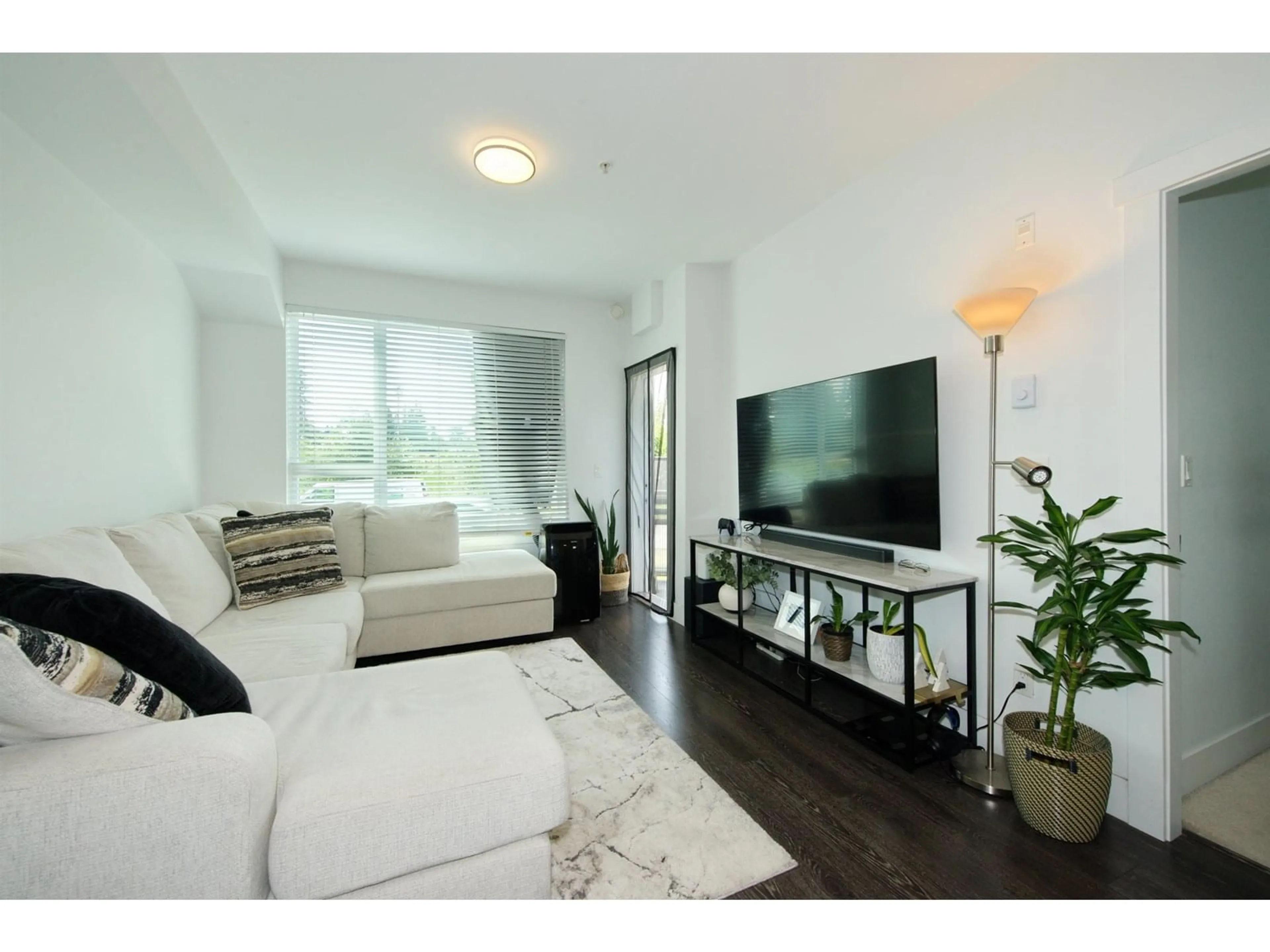 Living room with furniture, wood/laminate floor for 309 - 9983 BARNSTON EAST, Surrey British Columbia V4N6T3