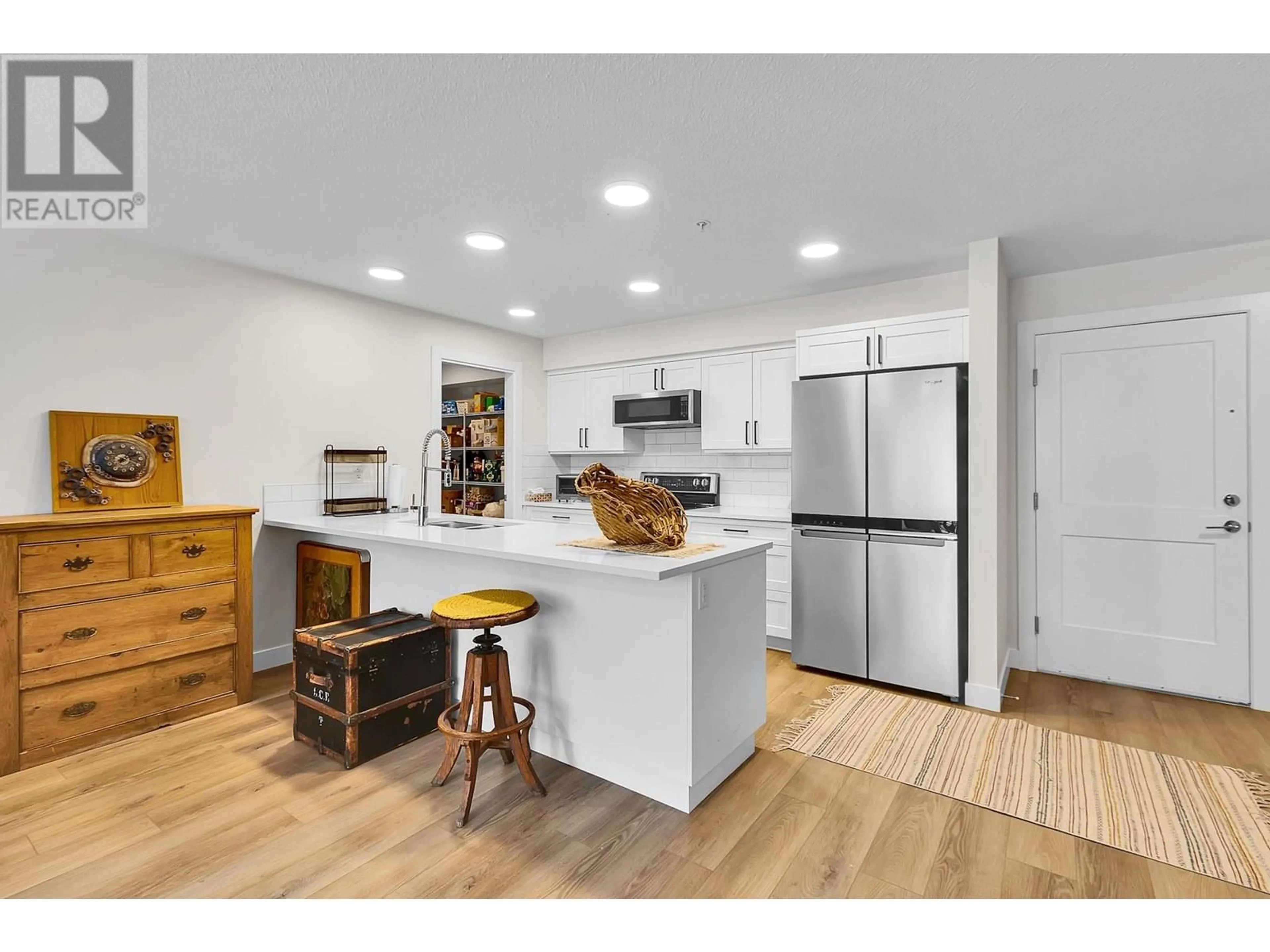 Open concept kitchen, wood/laminate floor for 205 - 4278 22ND AVENUE, Prince George British Columbia V2N0J4