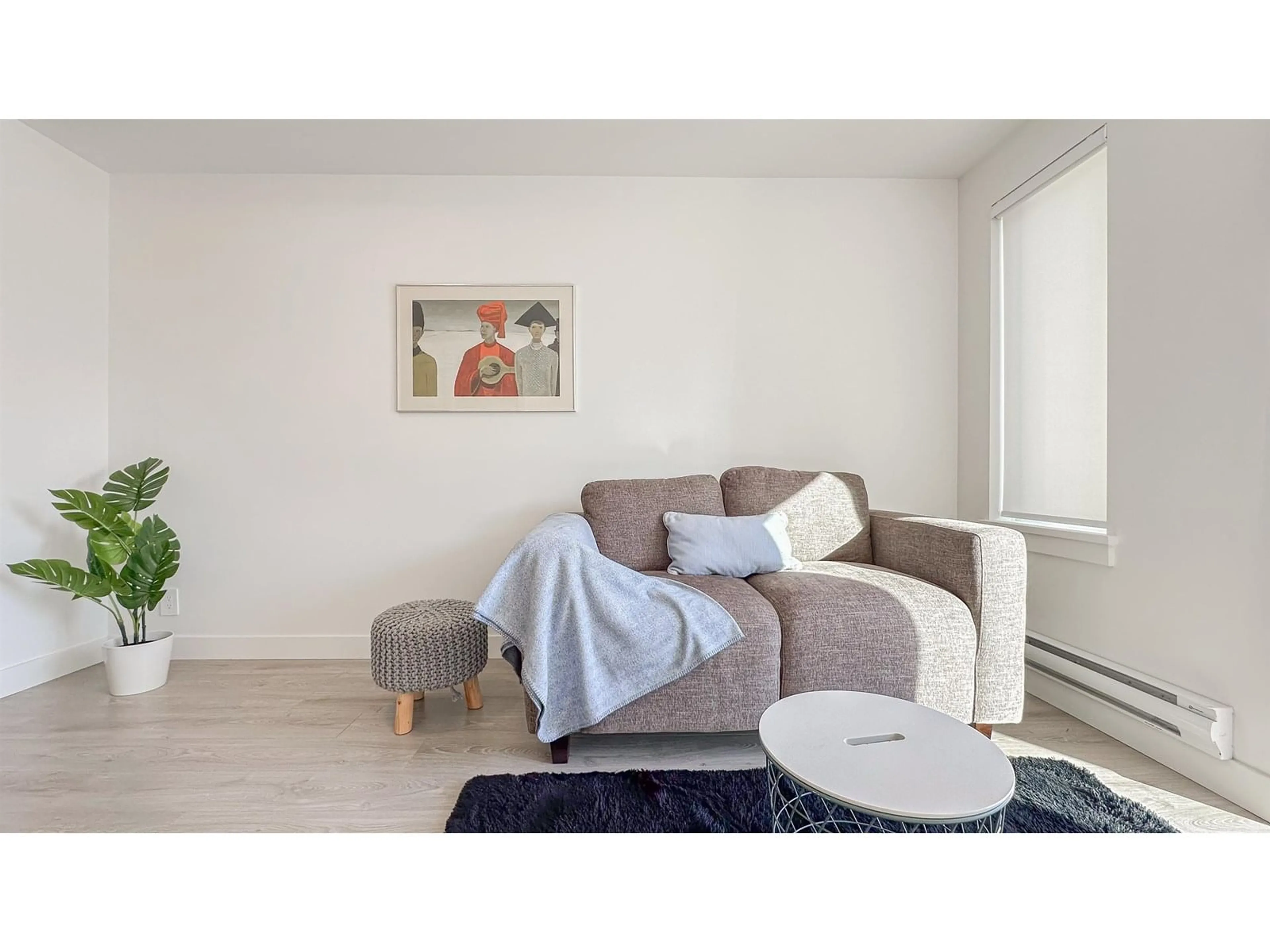 Living room with furniture, wood/laminate floor for 301 - 10616 132, Surrey British Columbia V3T0T3