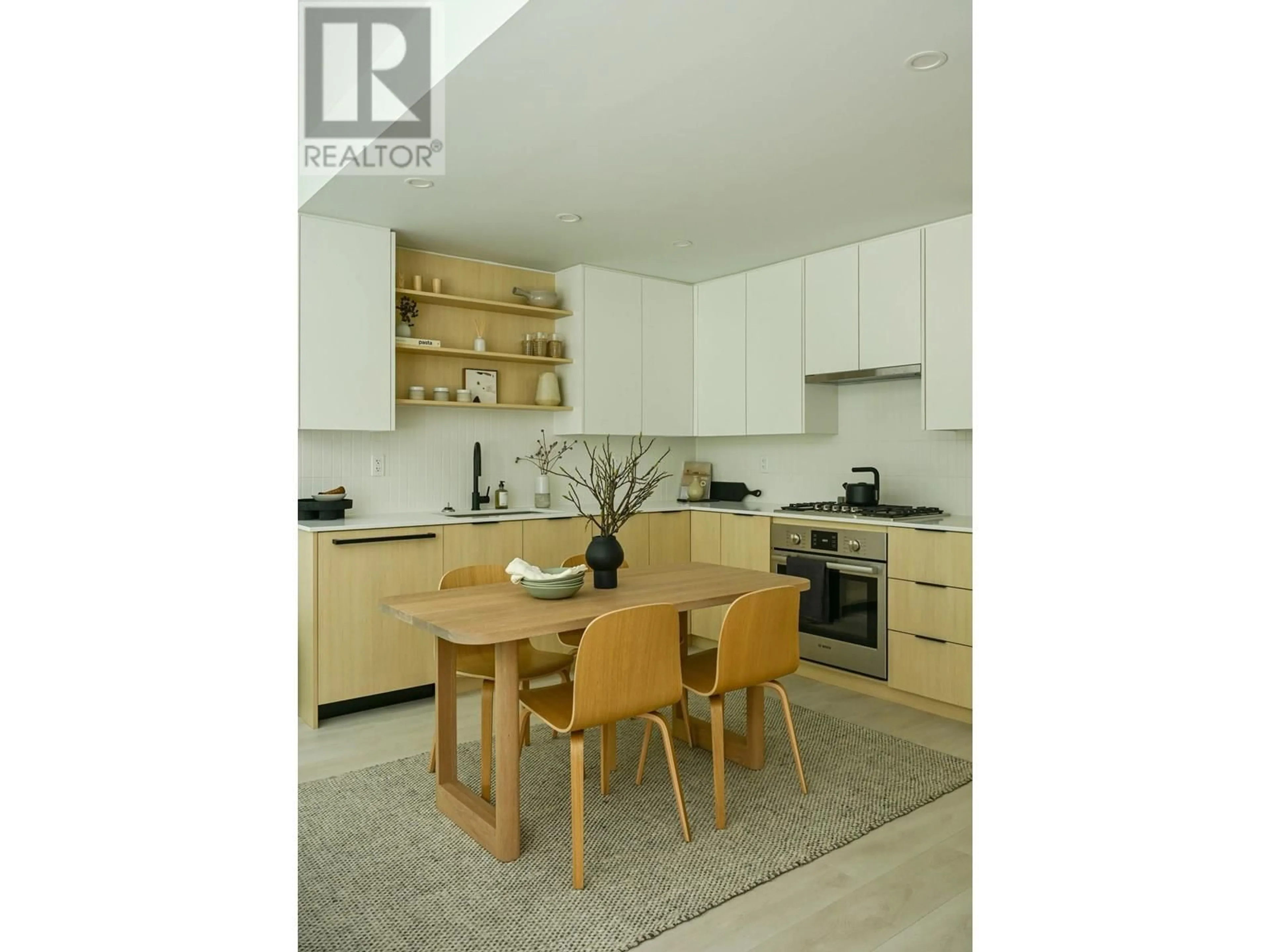 Open concept kitchen, wood/laminate floor for 207 - 2045 HERITAGE PARK LANE, North Vancouver British Columbia V7H0E3