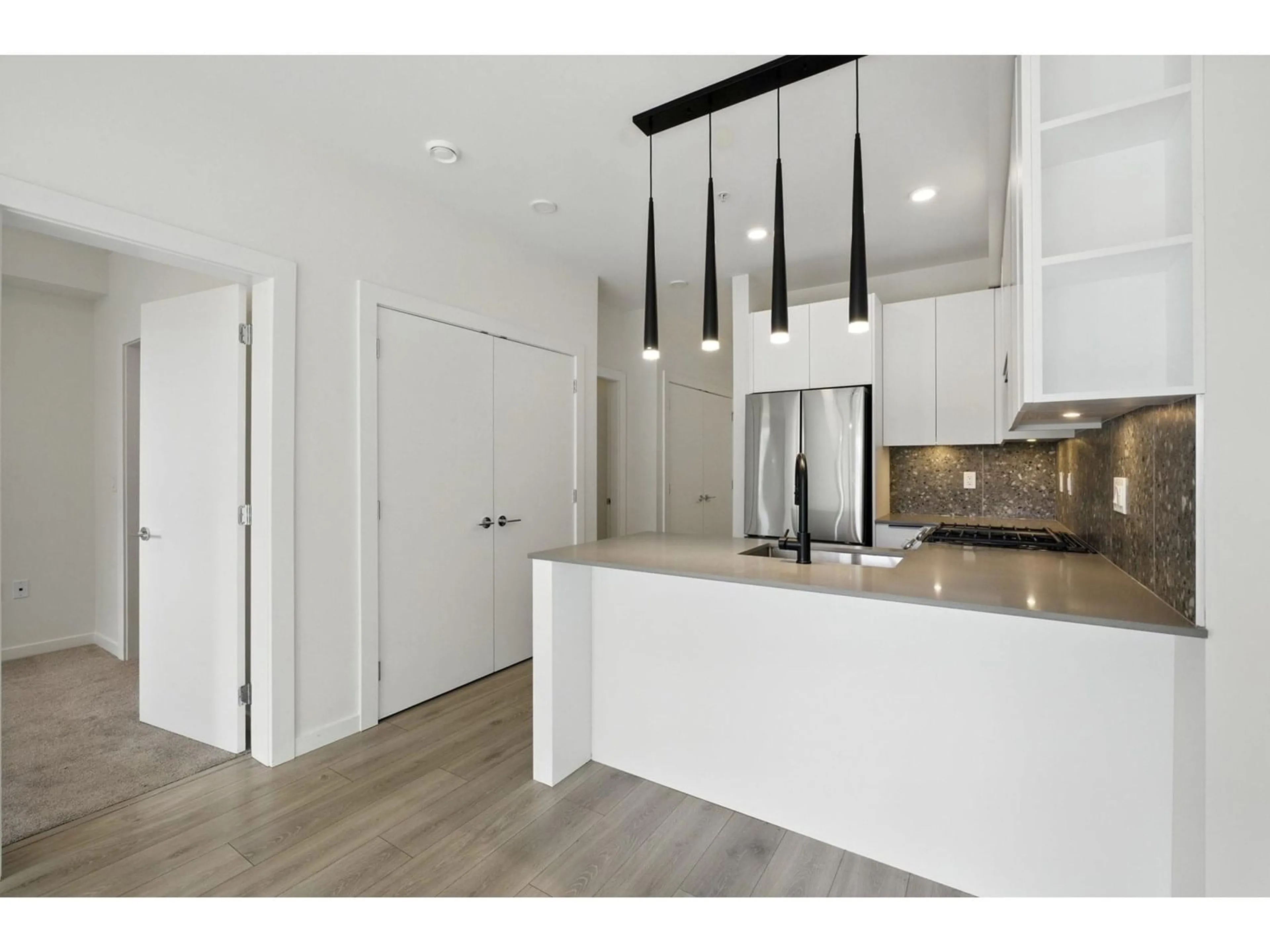 Open concept kitchen, wood/laminate floor for 310 - 7920 206, Langley British Columbia V2Y3X1