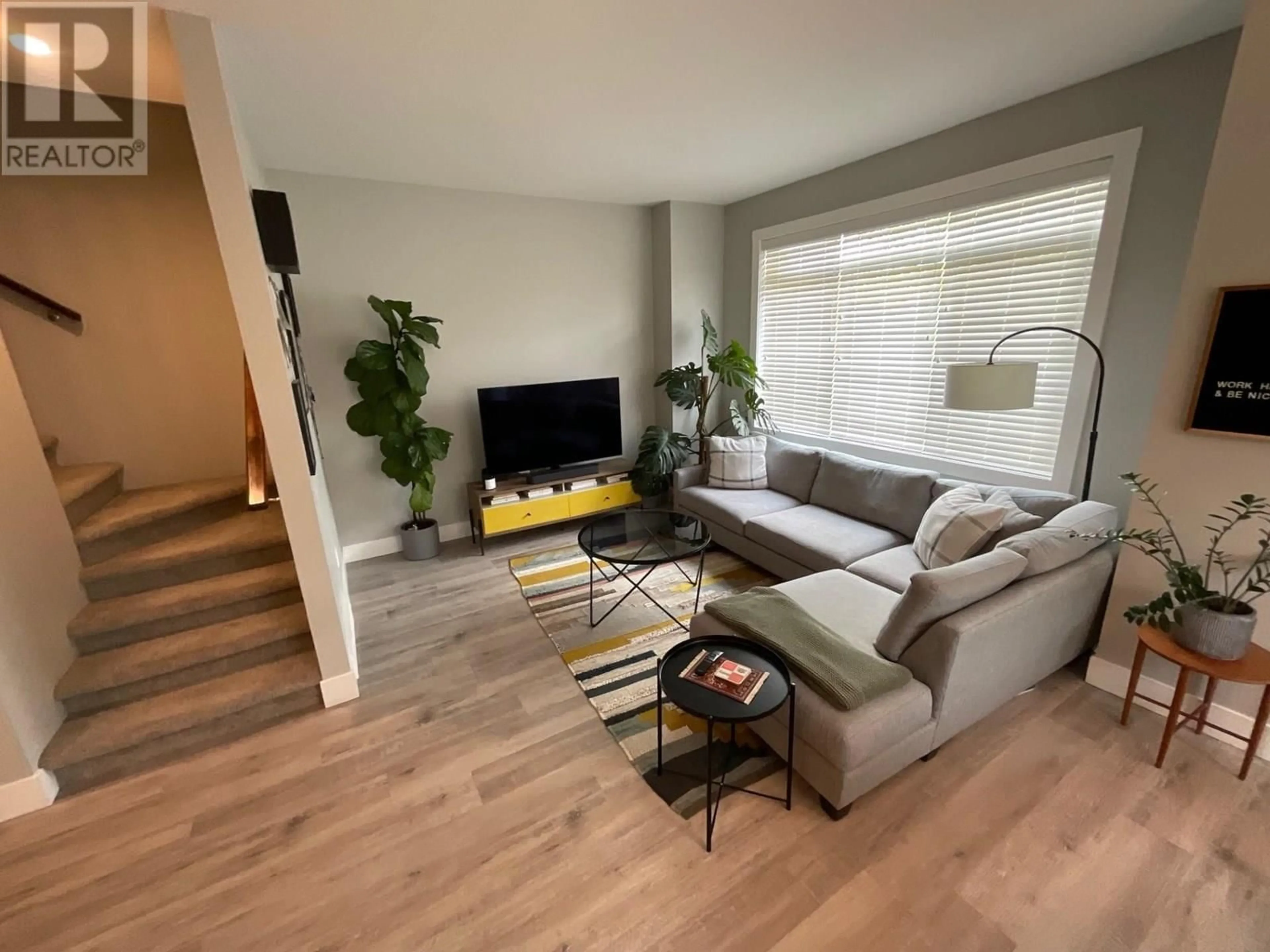 Living room with furniture, wood/laminate floor for 8404 88 AVENUE, Fort St. John British Columbia V1J0S2