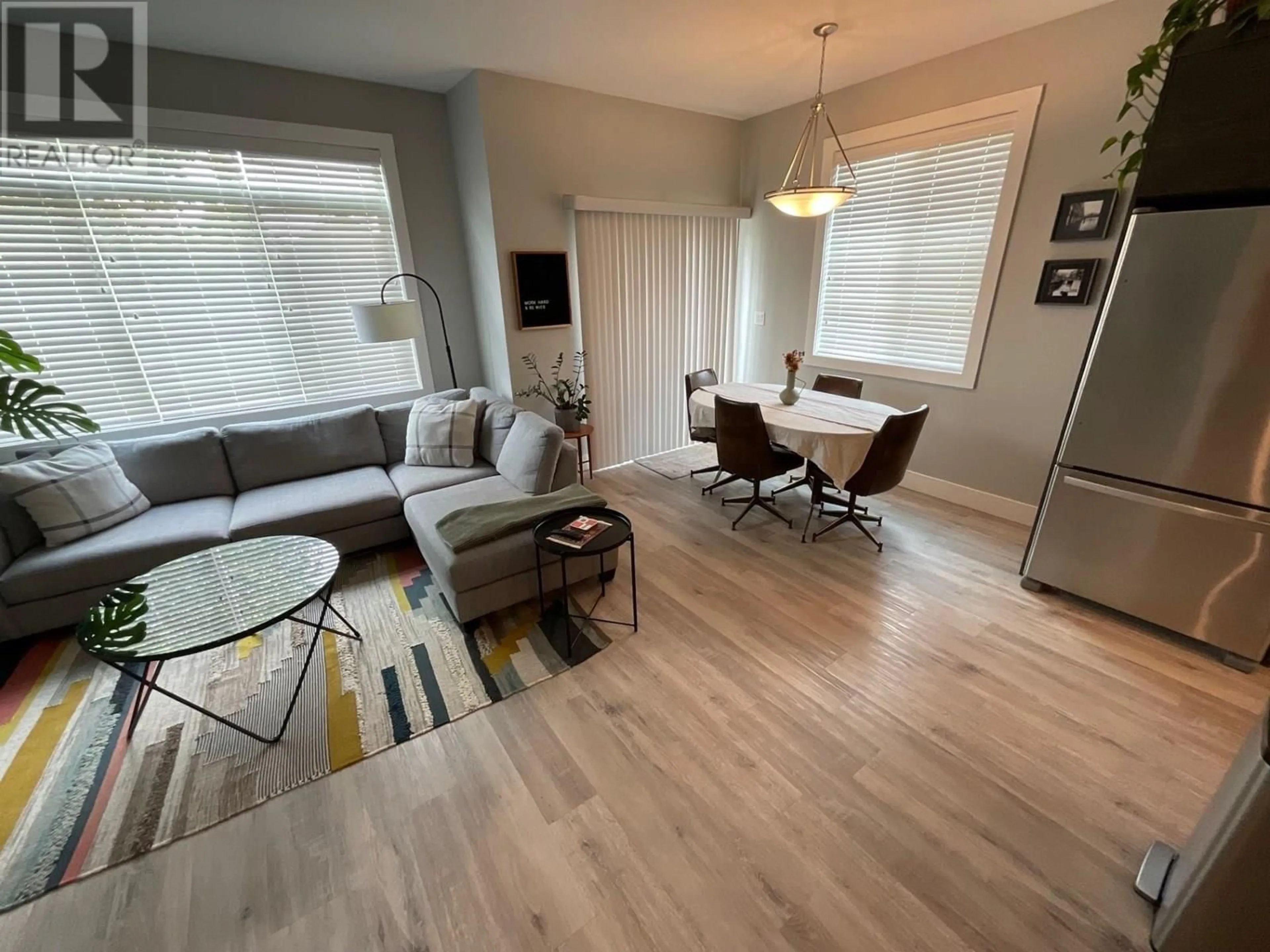 Living room with furniture, wood/laminate floor for 8404 88 AVENUE, Fort St. John British Columbia V1J0S2