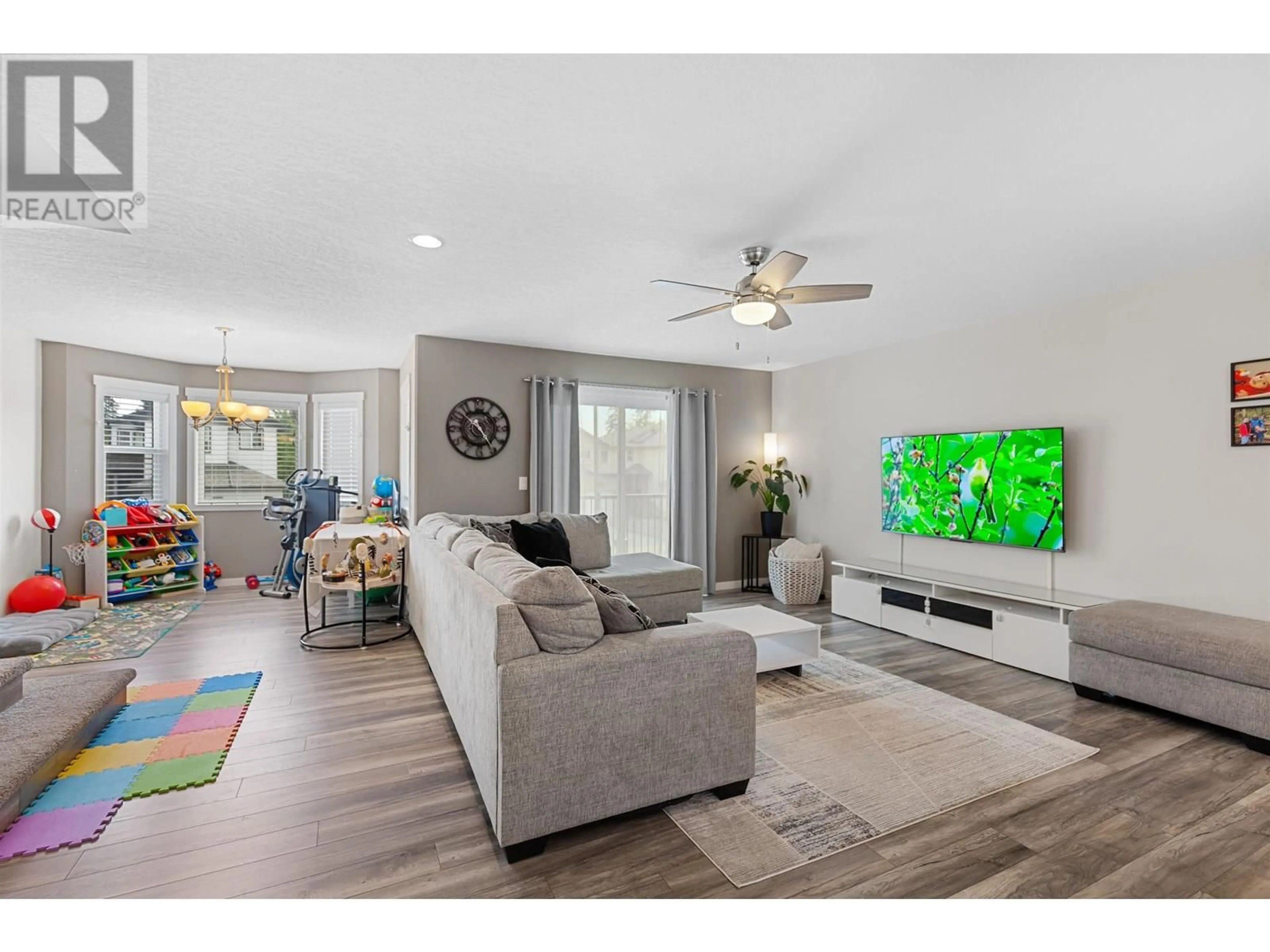 Living room with furniture, wood/laminate floor for 7645 CREEKSIDE WAY, Prince George British Columbia V2N0C2