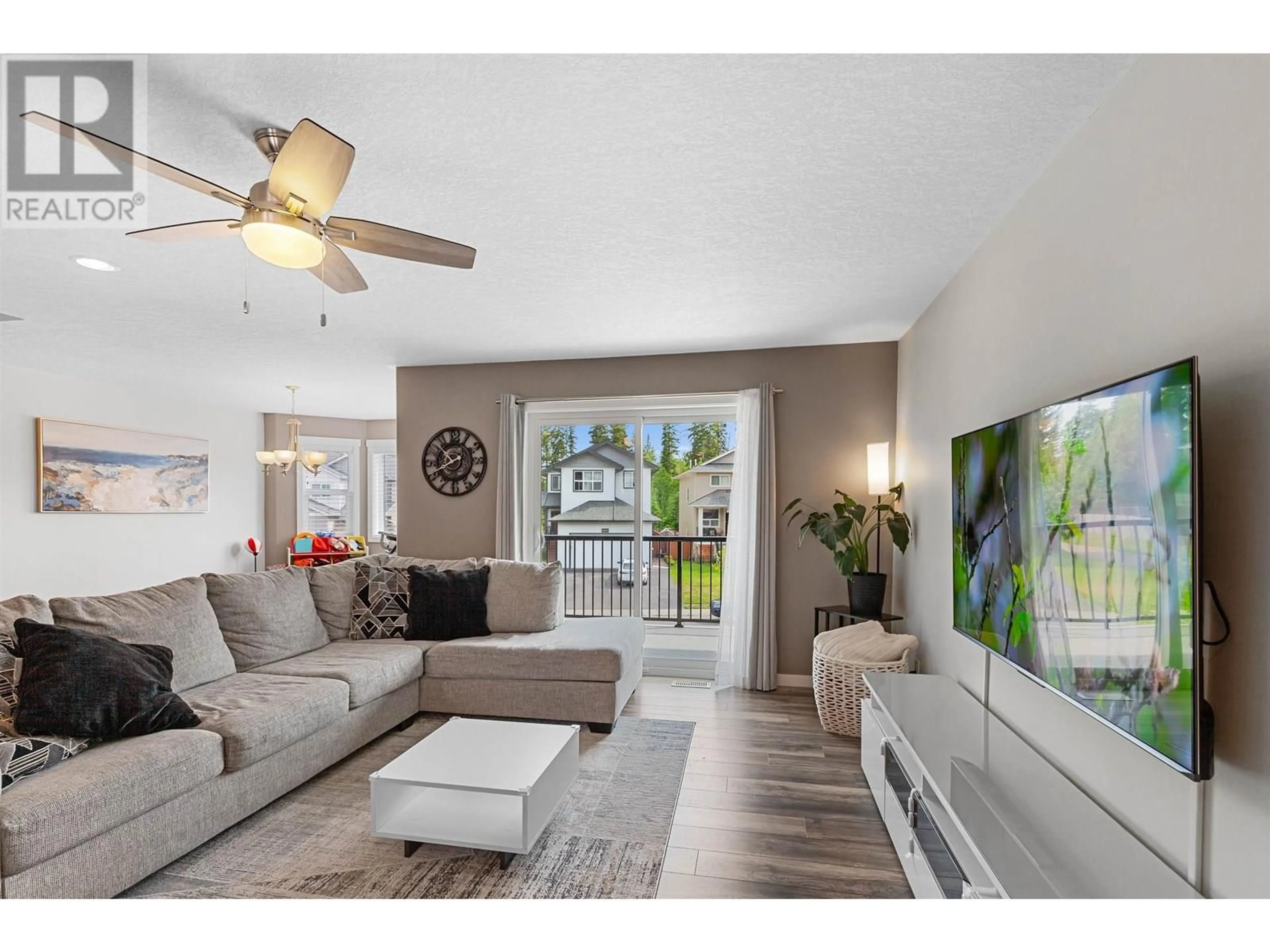 Living room with furniture, wood/laminate floor for 7645 CREEKSIDE WAY, Prince George British Columbia V2N0C2