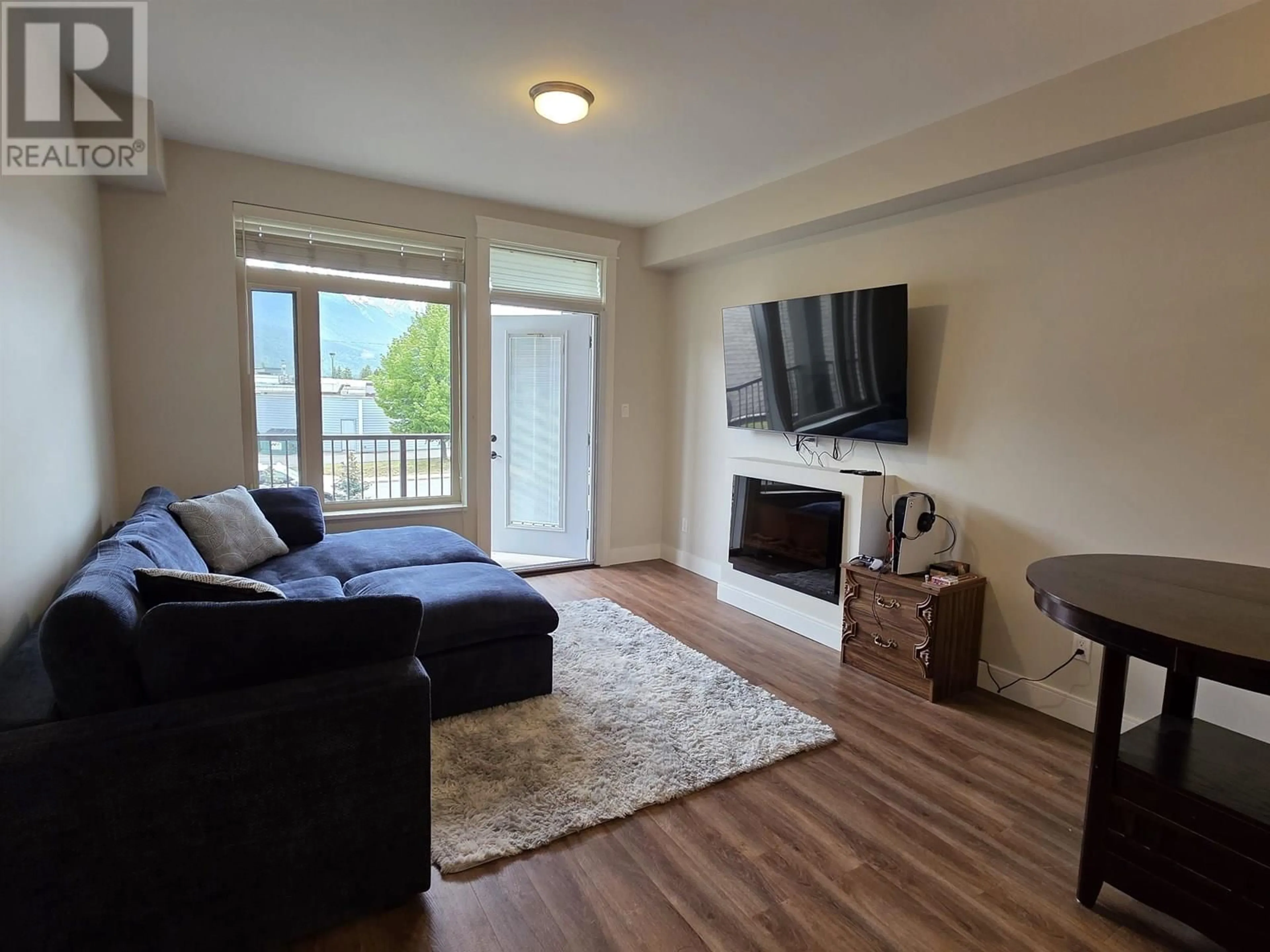 Living room with furniture, wood/laminate floor for 203 - 3684 PRINCESS CRESCENT, Smithers British Columbia V0J2N0