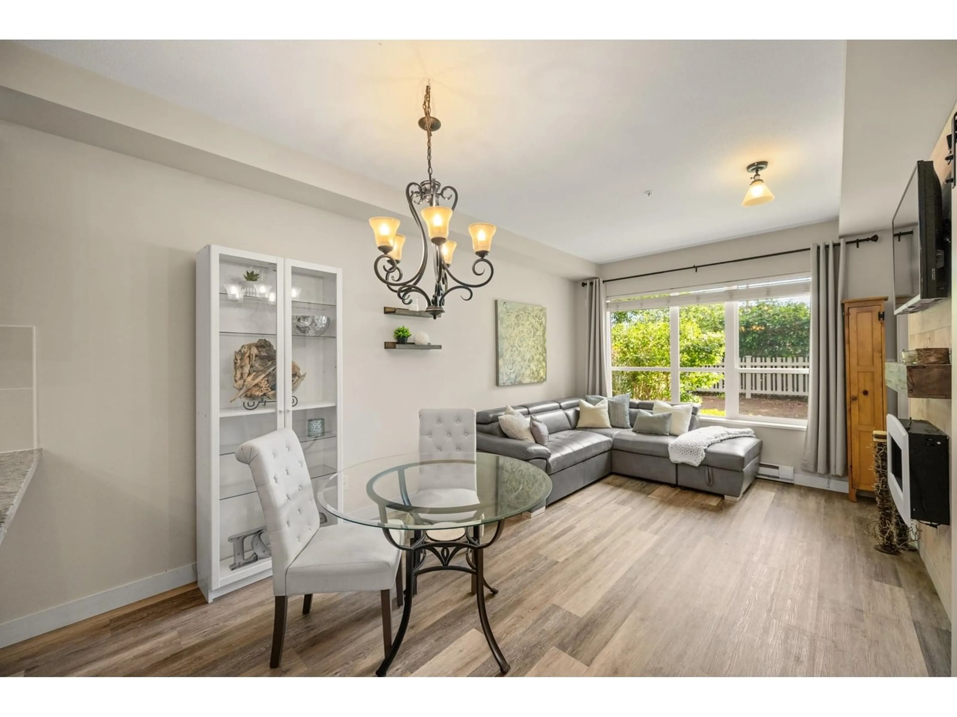 Living room with furniture, wood/laminate floor for 104 - 6440 194, Surrey British Columbia V4N6J7