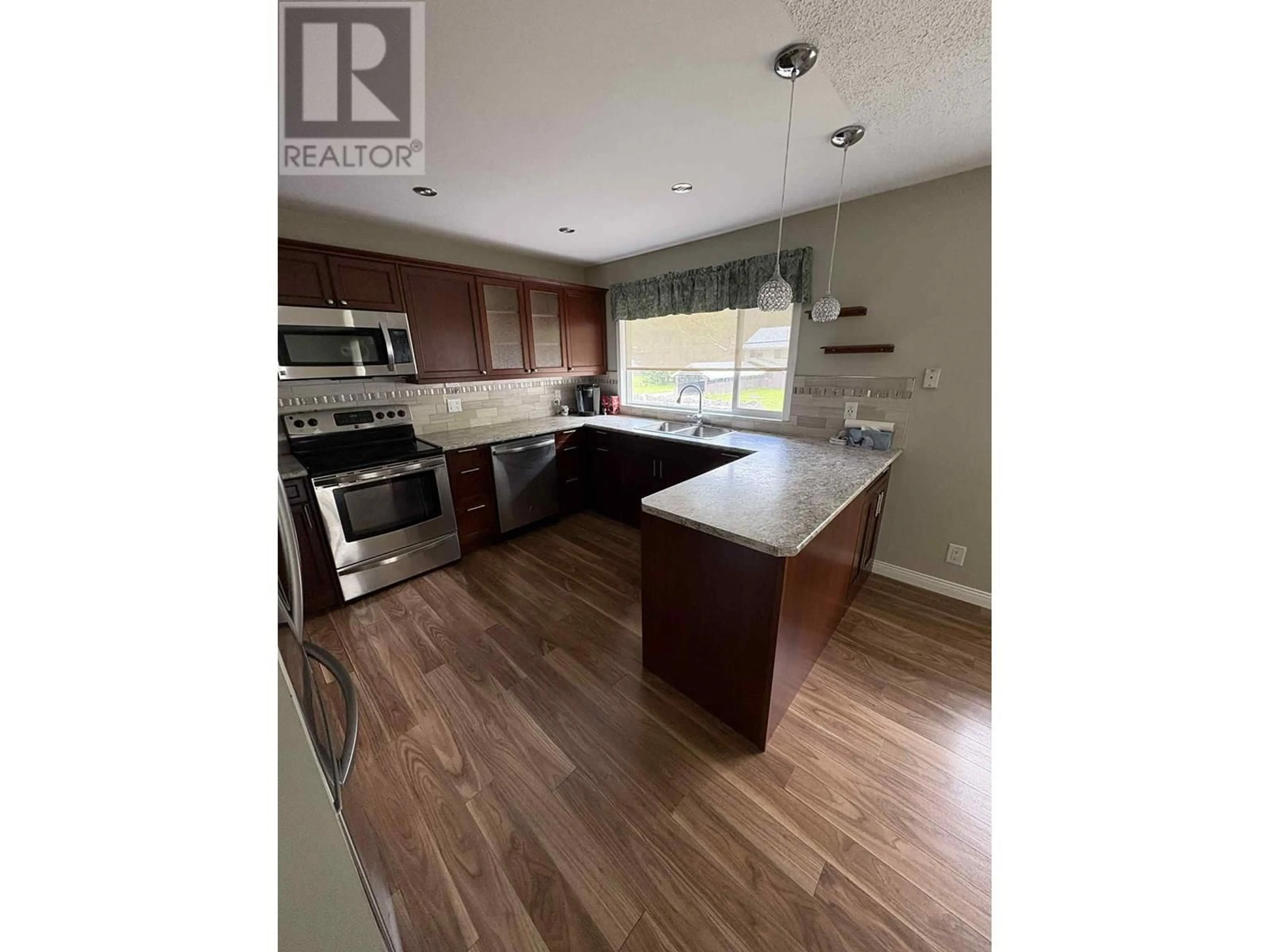 Open concept kitchen, wood/laminate floor for 1407 RAVEN STREET, Stewart British Columbia V0T1W0