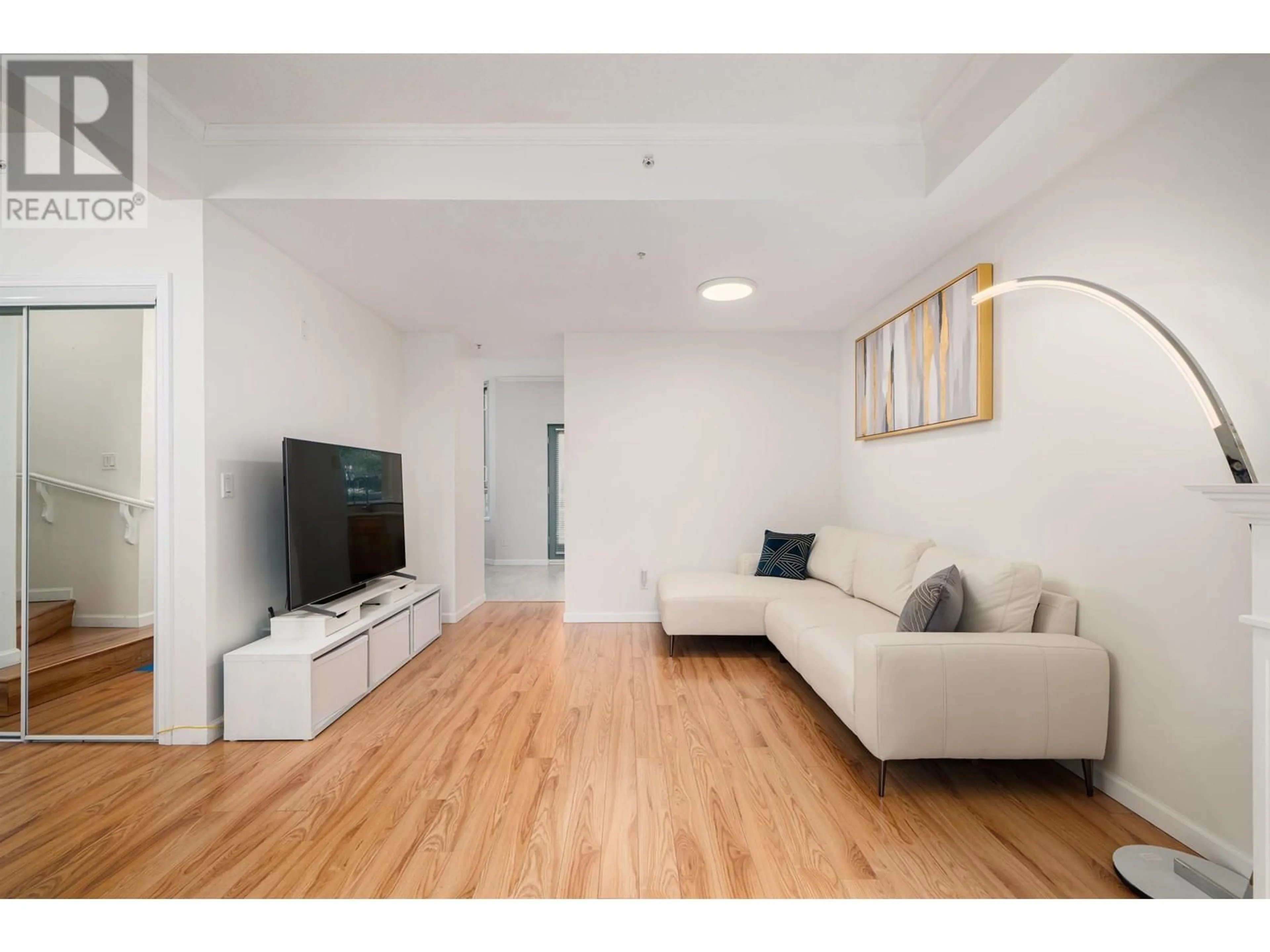 Living room with furniture, wood/laminate floor for 10 - 6611 SOUTHOAKS CRESCENT, Burnaby British Columbia V5E4L5
