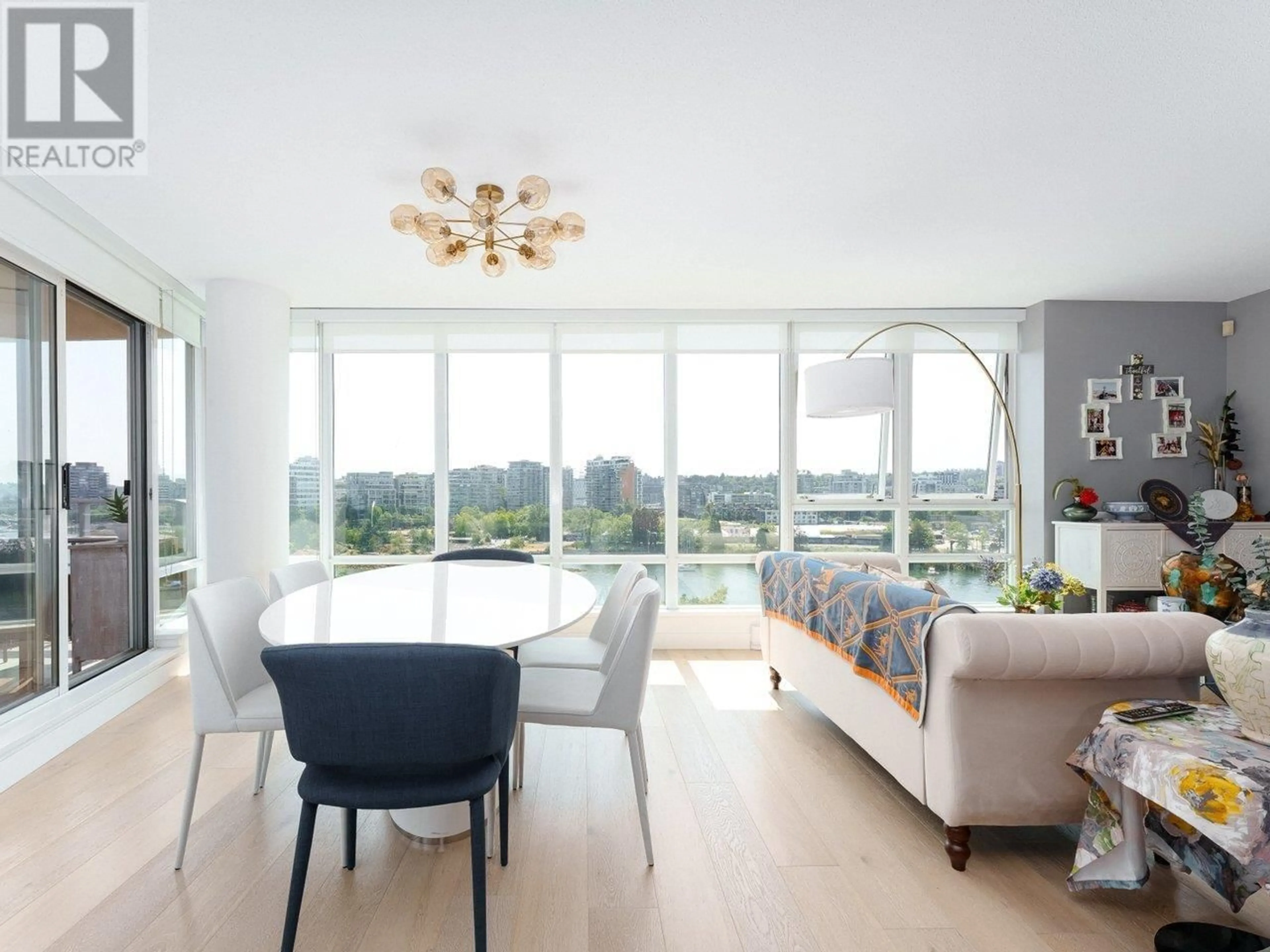 Living room with furniture, wood/laminate floor for 1006 - 980 COOPERAGE WAY, Vancouver British Columbia V6B0C3