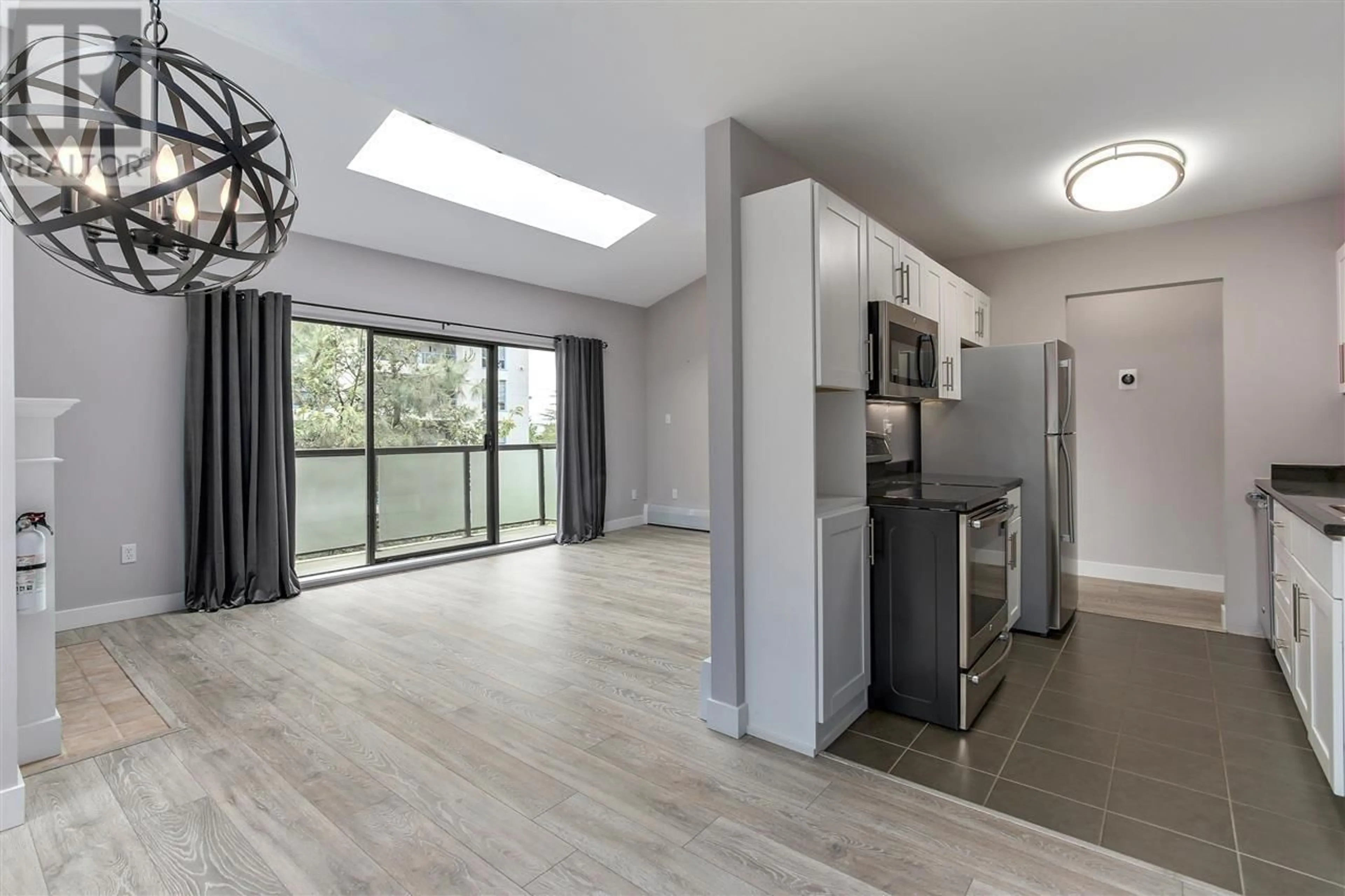 Open concept kitchen, wood/laminate floor for 306 - 1345 W 15TH AVENUE, Vancouver British Columbia V6H3R3