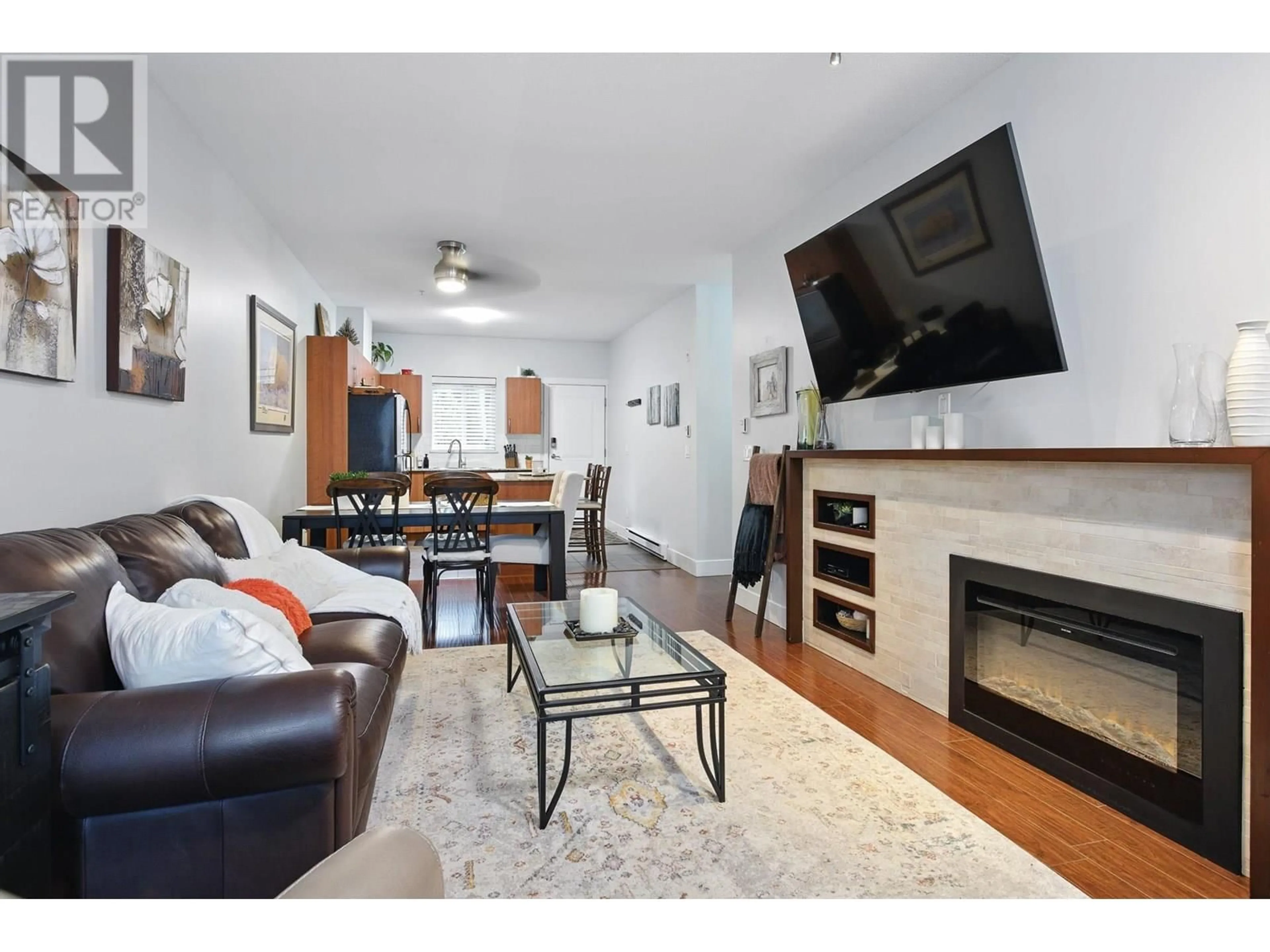 Living room with furniture, wood/laminate floor for 407 - 1661 FRASER AVENUE, Port Coquitlam British Columbia V3B0B6