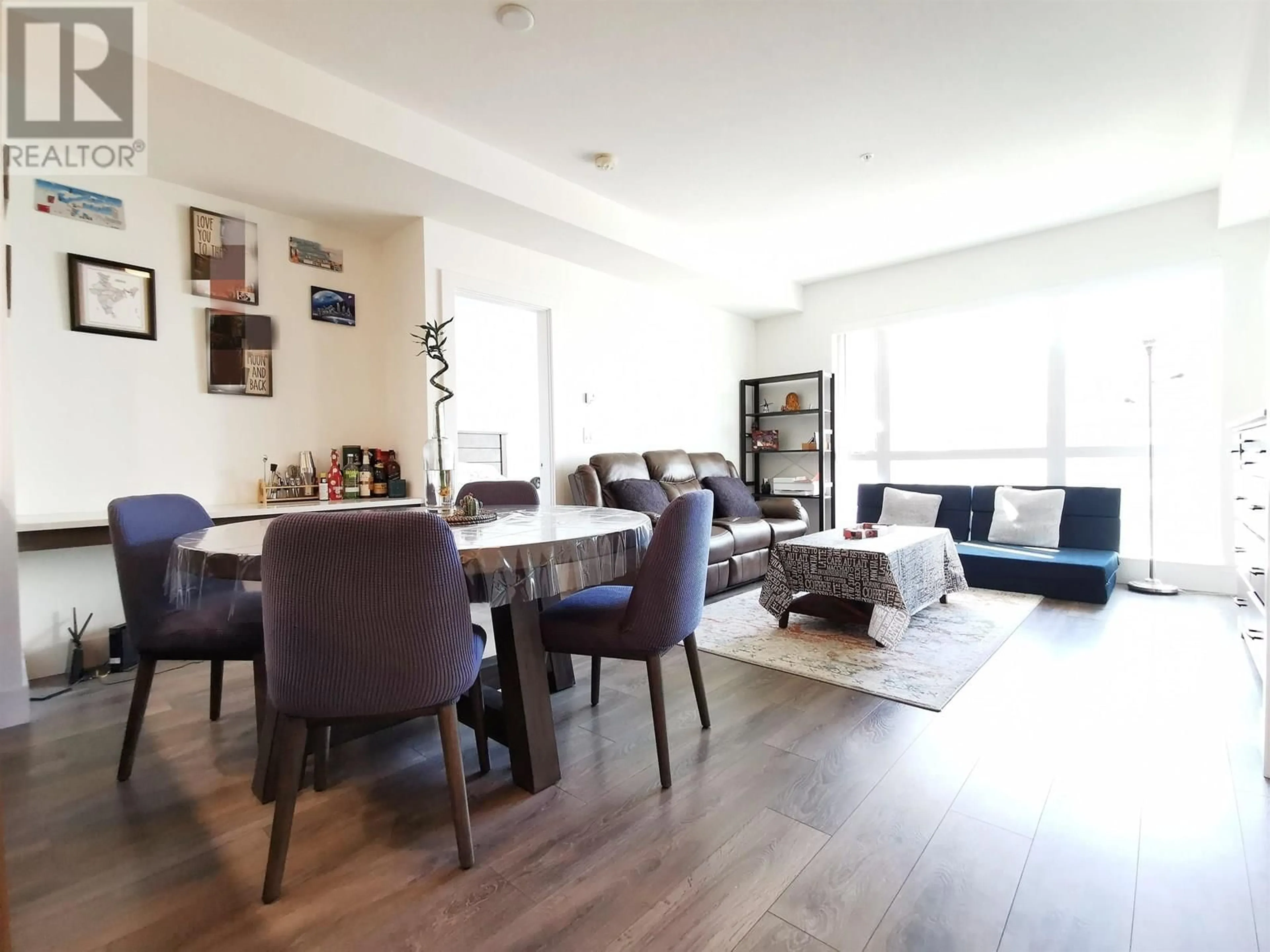 Living room with furniture, wood/laminate floor for 607 - 8580 RIVER DISTRICT CROSSING, Vancouver British Columbia V5S0B9