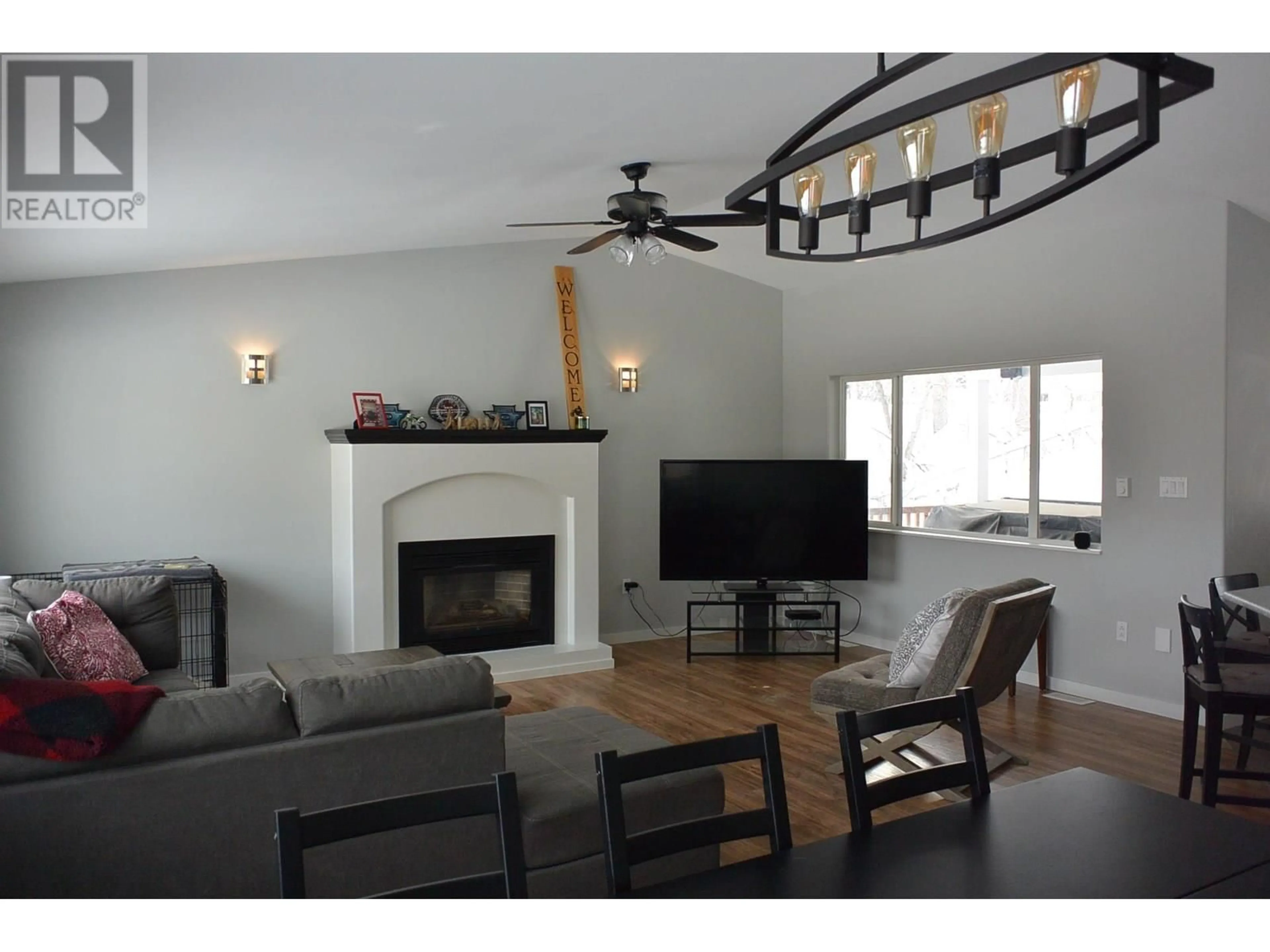 Living room with furniture, wood/laminate floor for 127 GEMINI STREET, Quesnel British Columbia V2J5X8