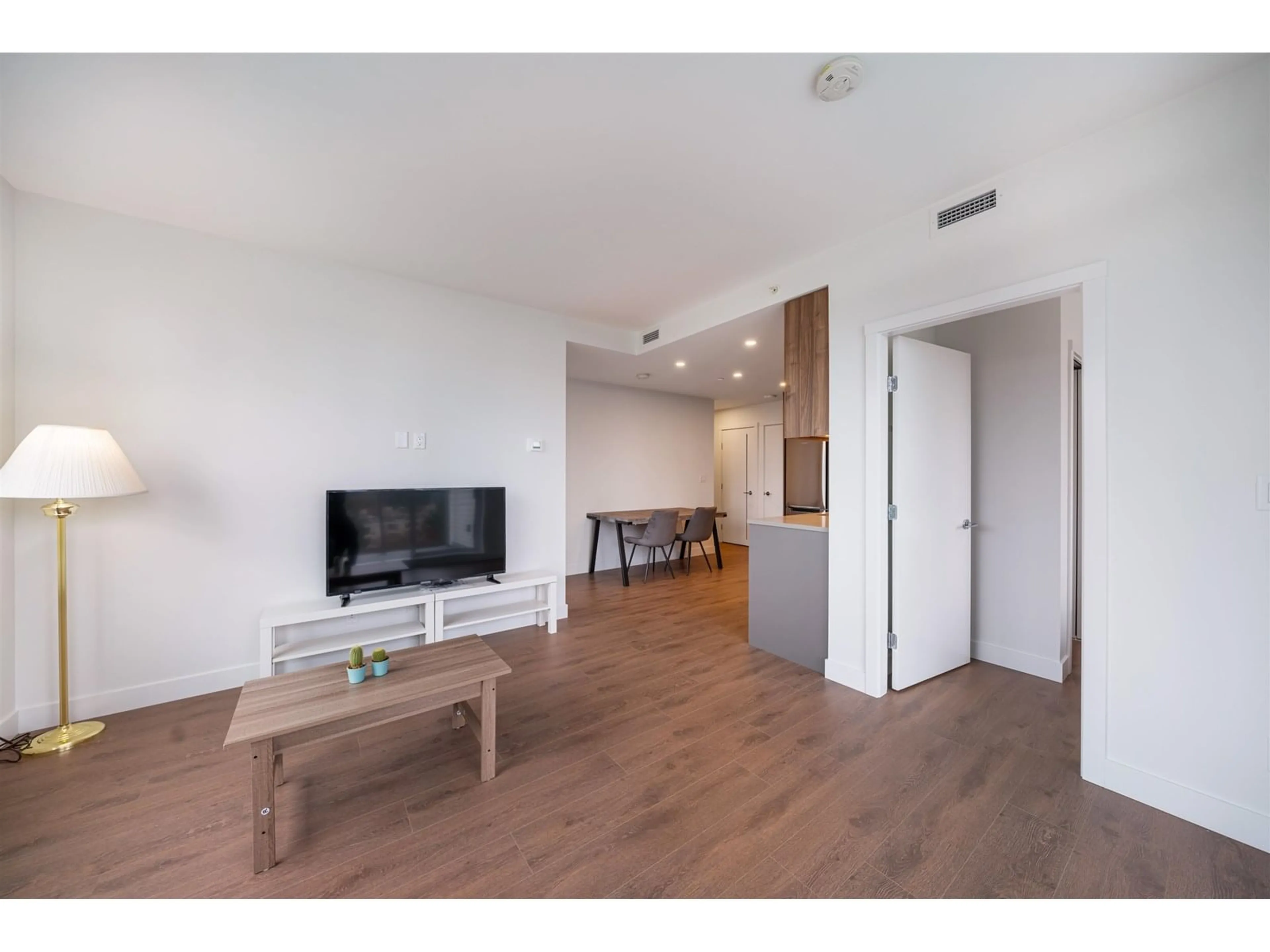 Living room with furniture, wood/laminate floor for 402 - 13359 OLD YALE, Surrey British Columbia V3T0S4
