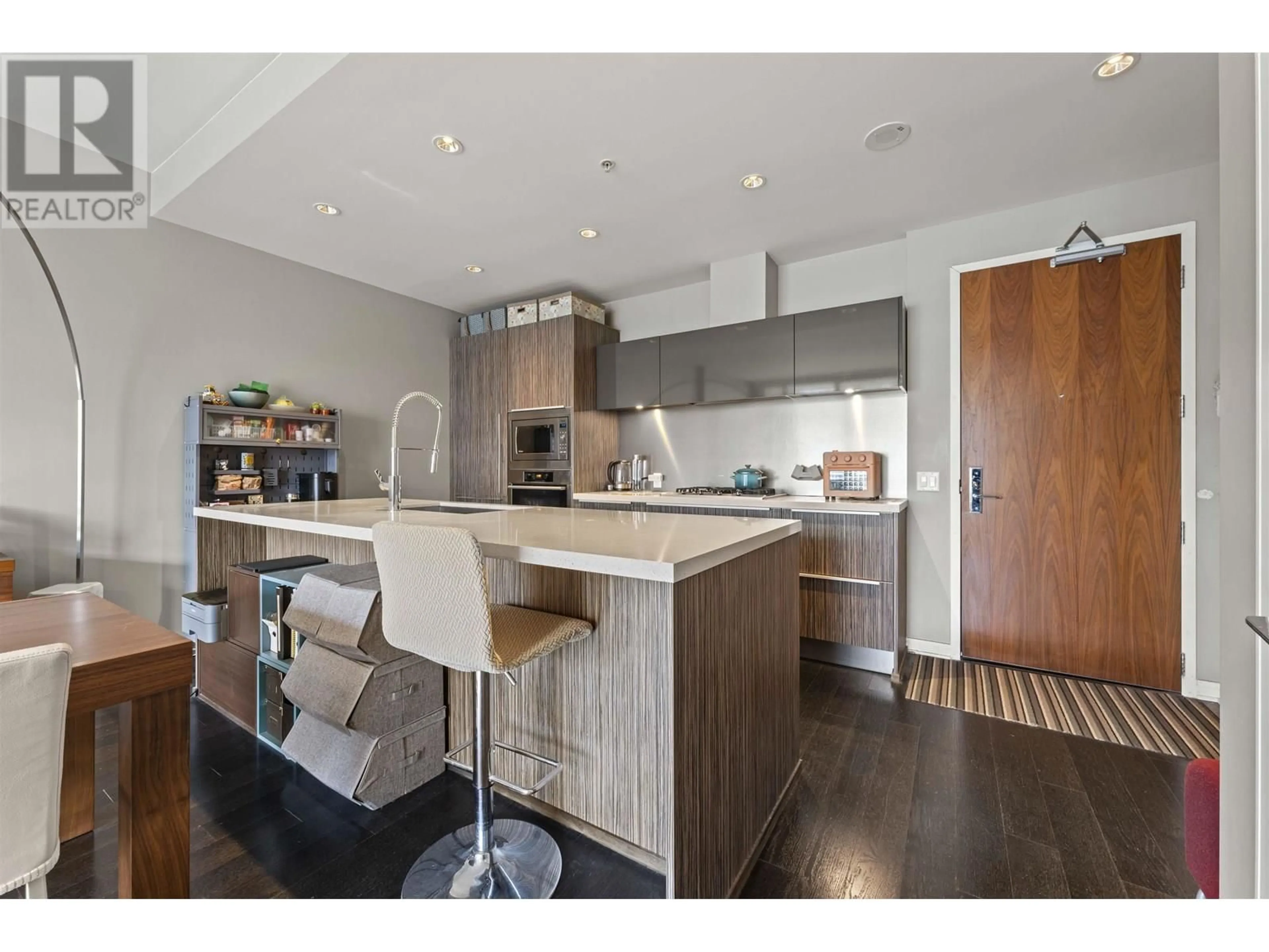 Open concept kitchen, wood/laminate floor for 502 - 77 WALTER HARDWICK AVENUE, Vancouver British Columbia V5Y0C6