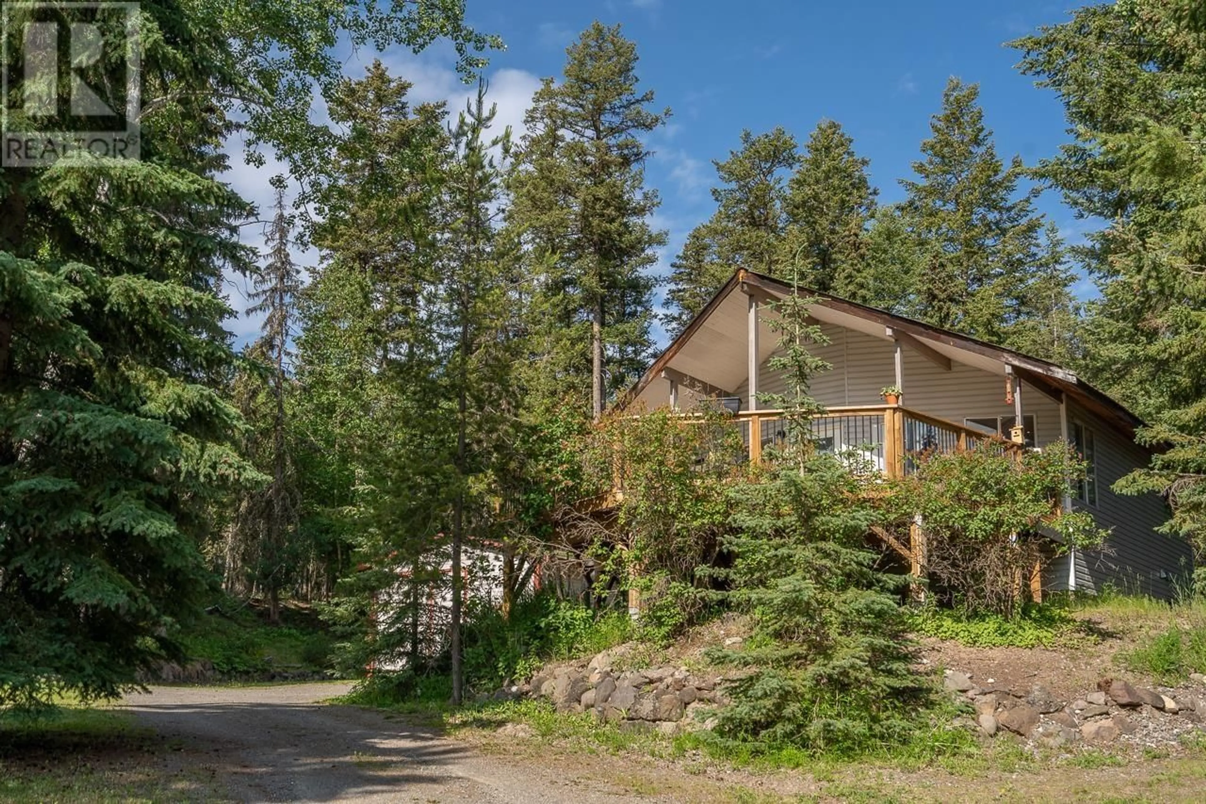 A pic from outside/outdoor area/front of a property/back of a property/a pic from drone, forest/trees view for 5324 KALLUM DRIVE, 108 Mile Ranch British Columbia V0K2Z0