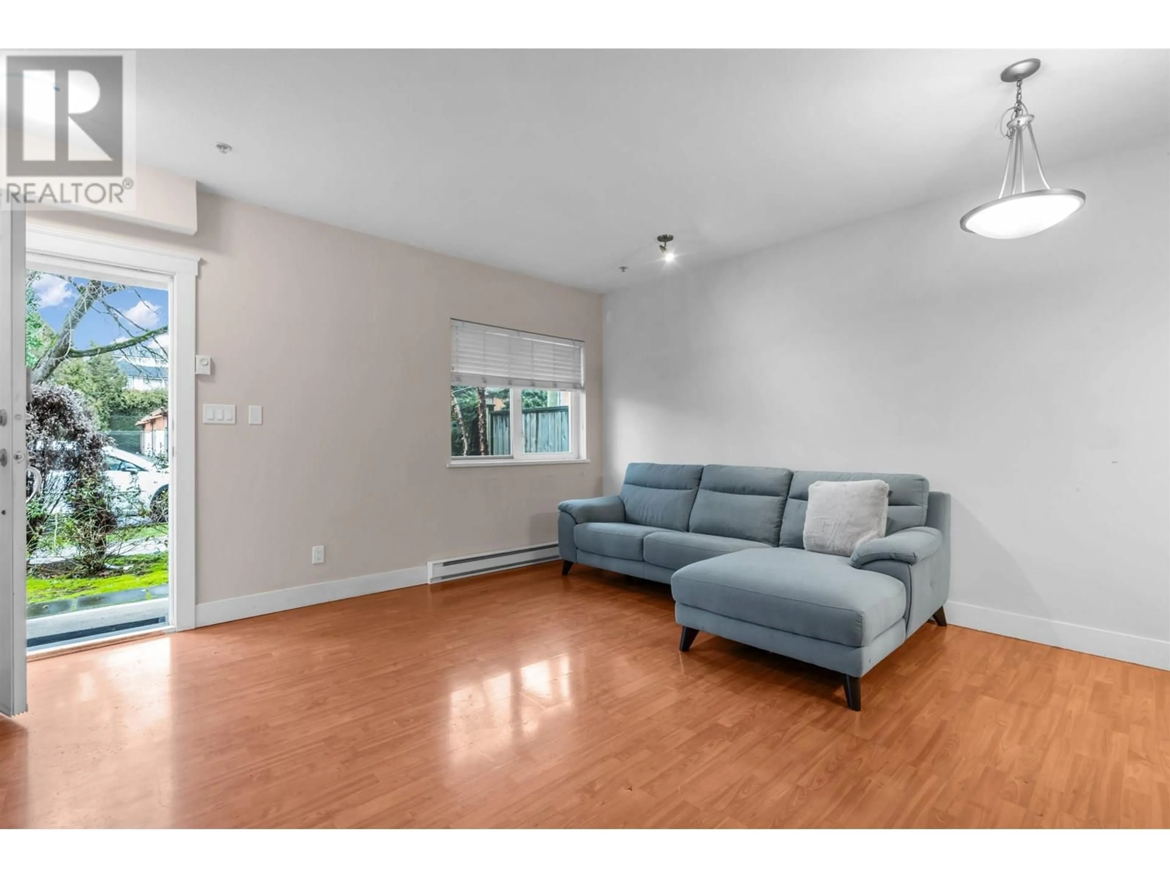 Living room with furniture, wood/laminate floor for 1 - 8400 COOK ROAD, Richmond British Columbia V6Y1V5