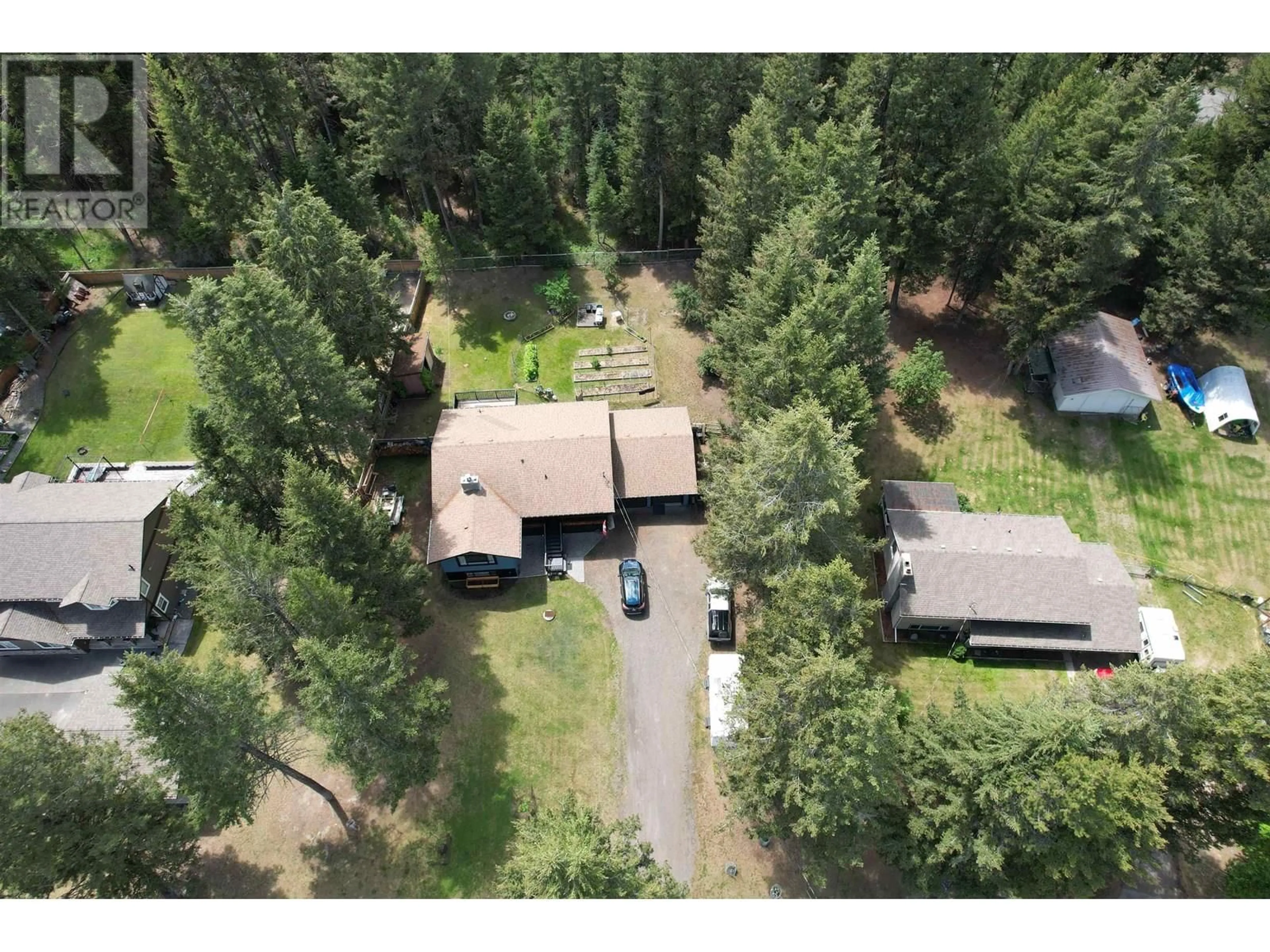 A pic from outside/outdoor area/front of a property/back of a property/a pic from drone, forest/trees view for 4990 CANIUM COURT, 100 Mile House British Columbia V0K2E0