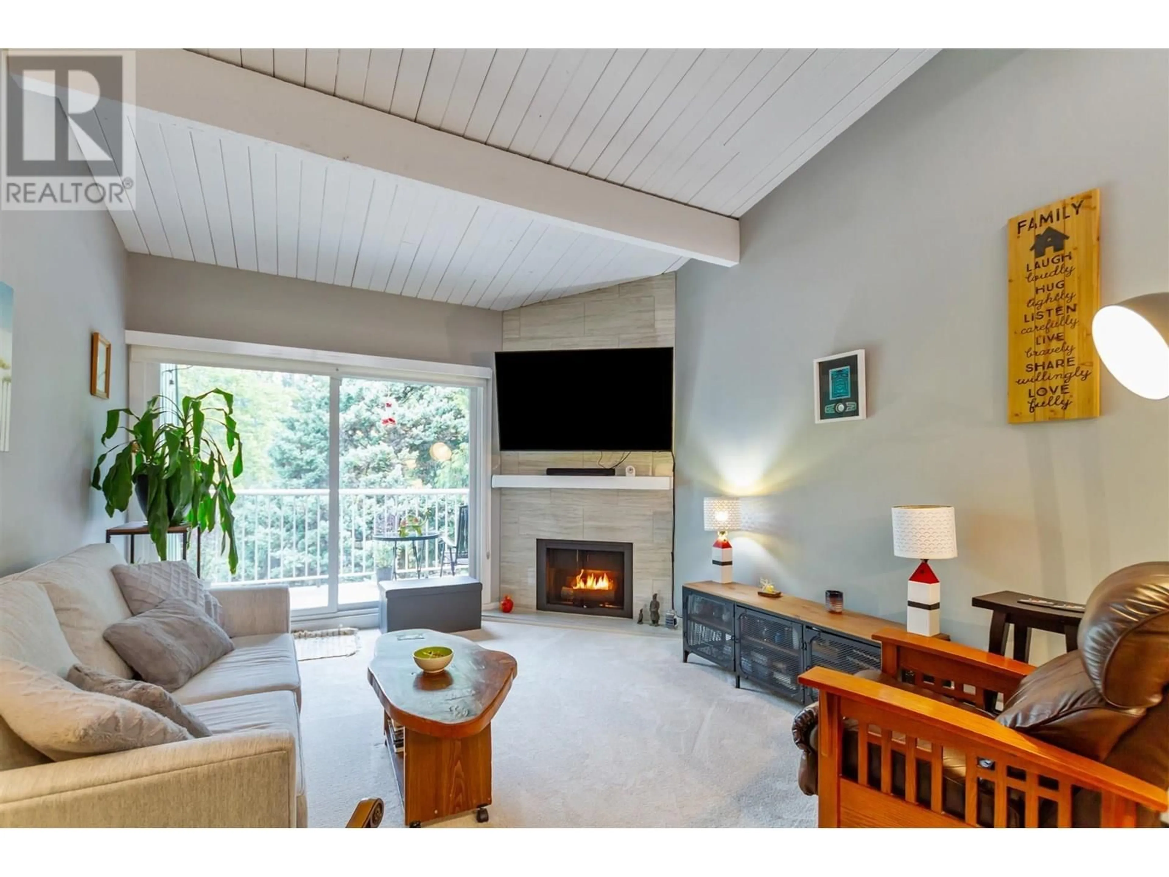 Living room with furniture, wood/laminate floor for 305 - 3901 CARRIGAN COURT, Burnaby British Columbia V3N4K1