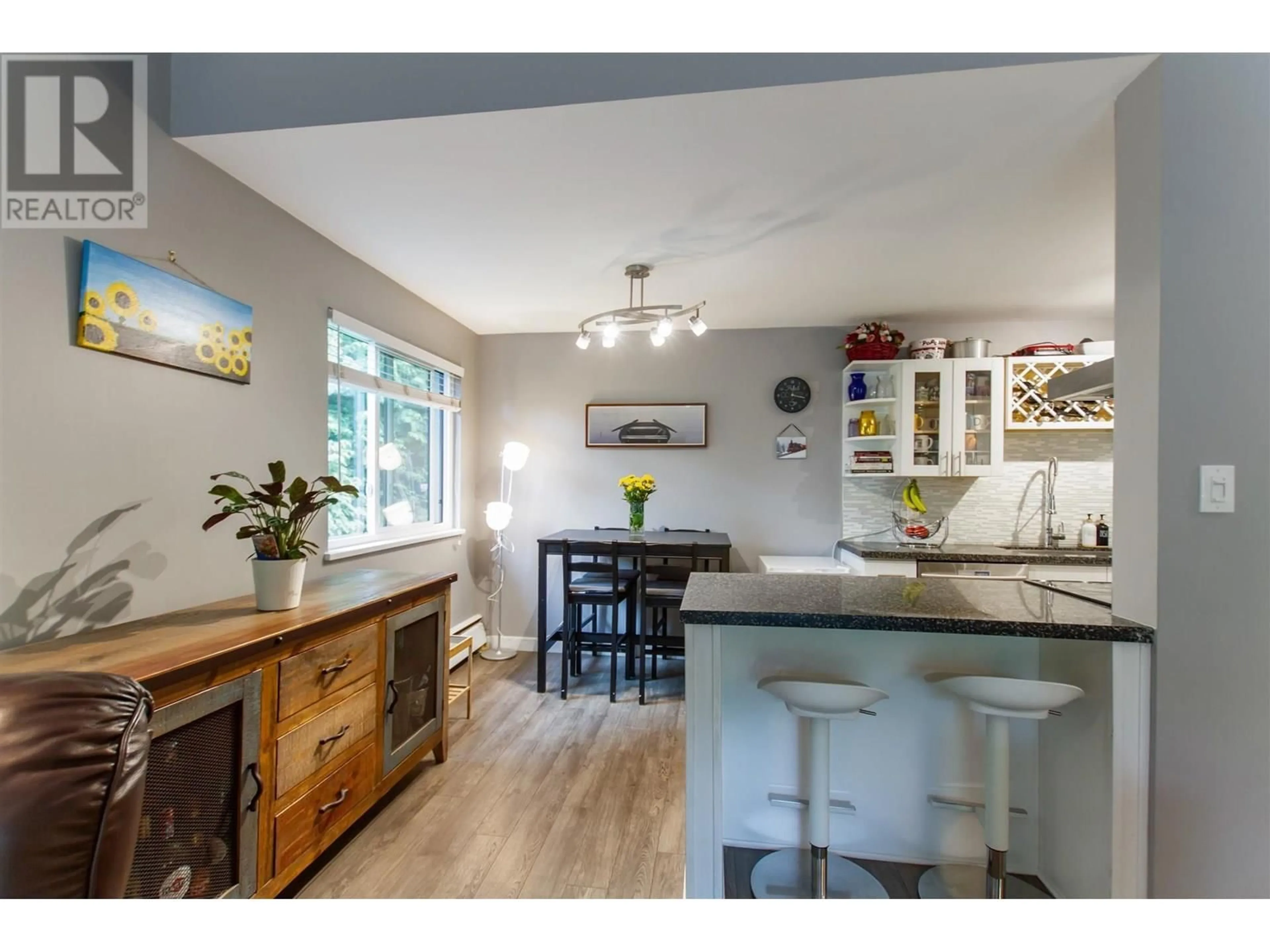 Open concept kitchen, wood/laminate floor for 305 - 3901 CARRIGAN COURT, Burnaby British Columbia V3N4K1
