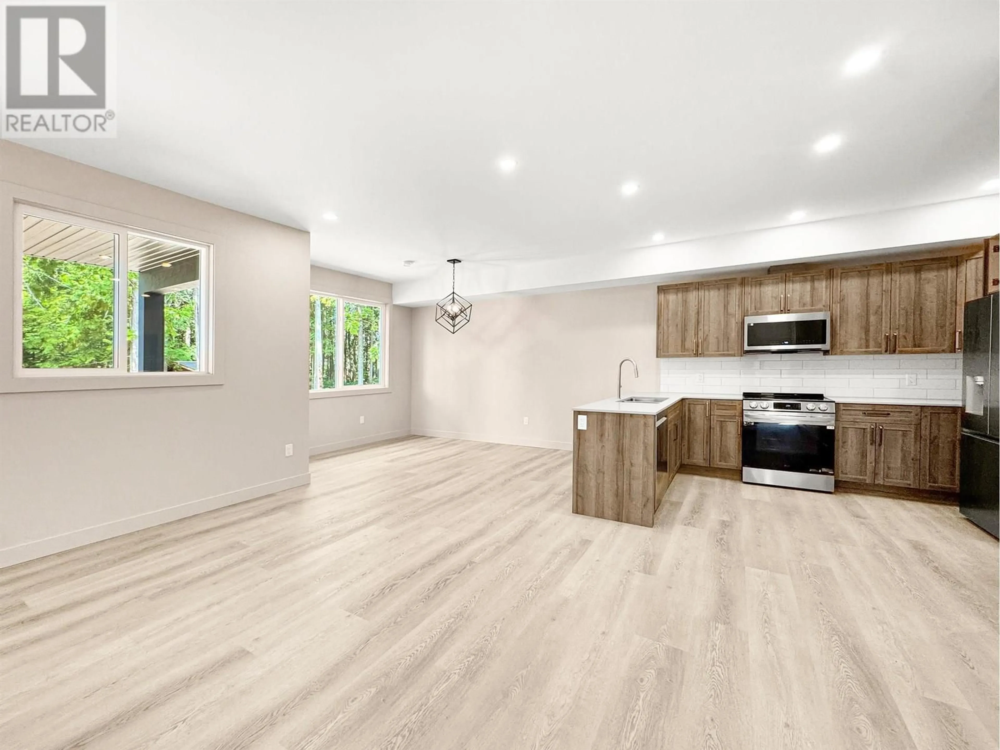 Open concept kitchen, wood/laminate floor for 1 - 4007 BENNER STREET, Terrace British Columbia V8G3A9