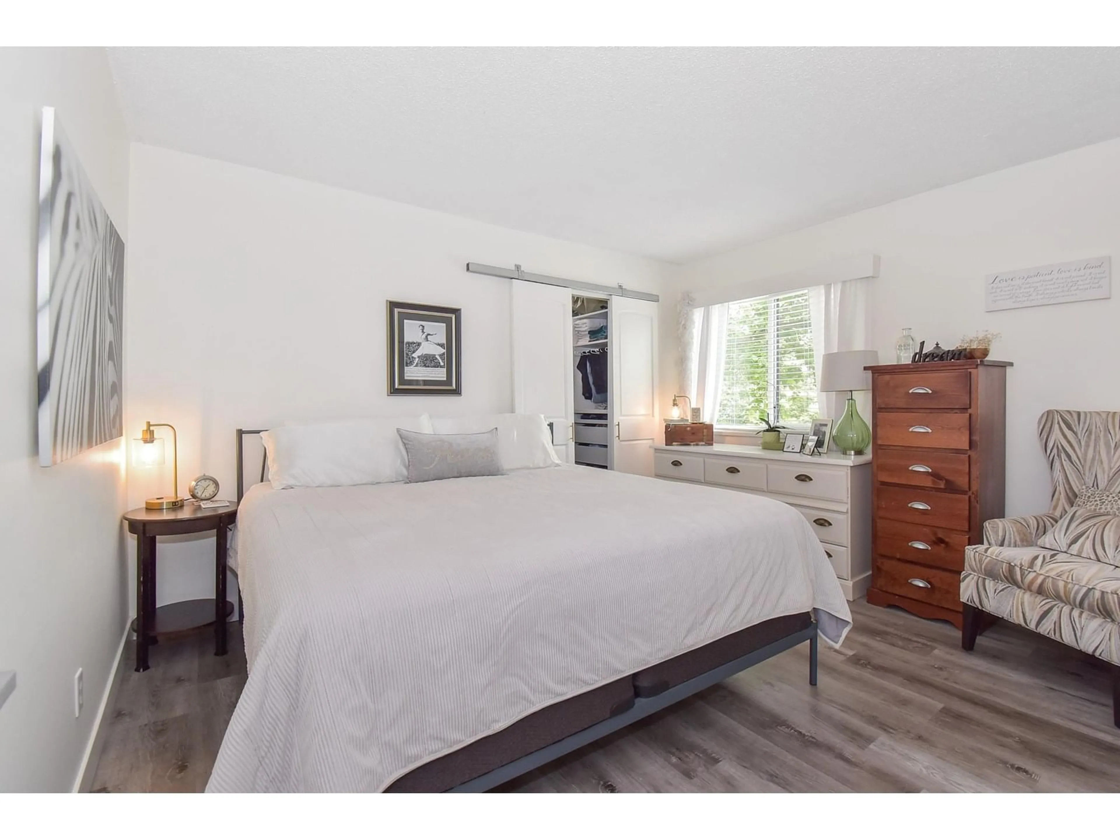 Bedroom with bed, wood/laminate floor for 101 - 5906 176A, Surrey British Columbia V3S4H7