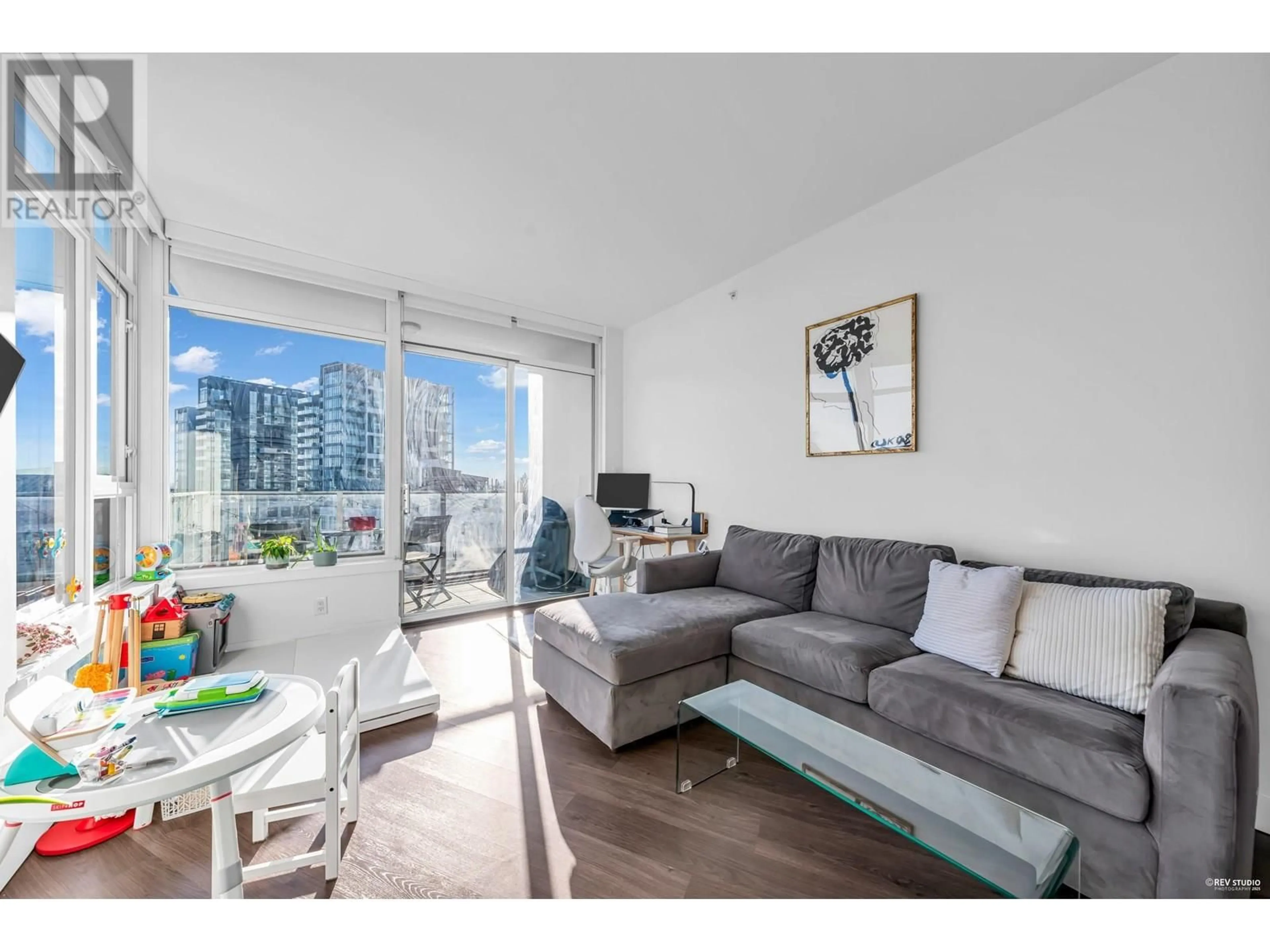Living room with furniture, wood/laminate floor for 716 - 3557 SAWMILL CRESCENT, Vancouver British Columbia V5S0E2