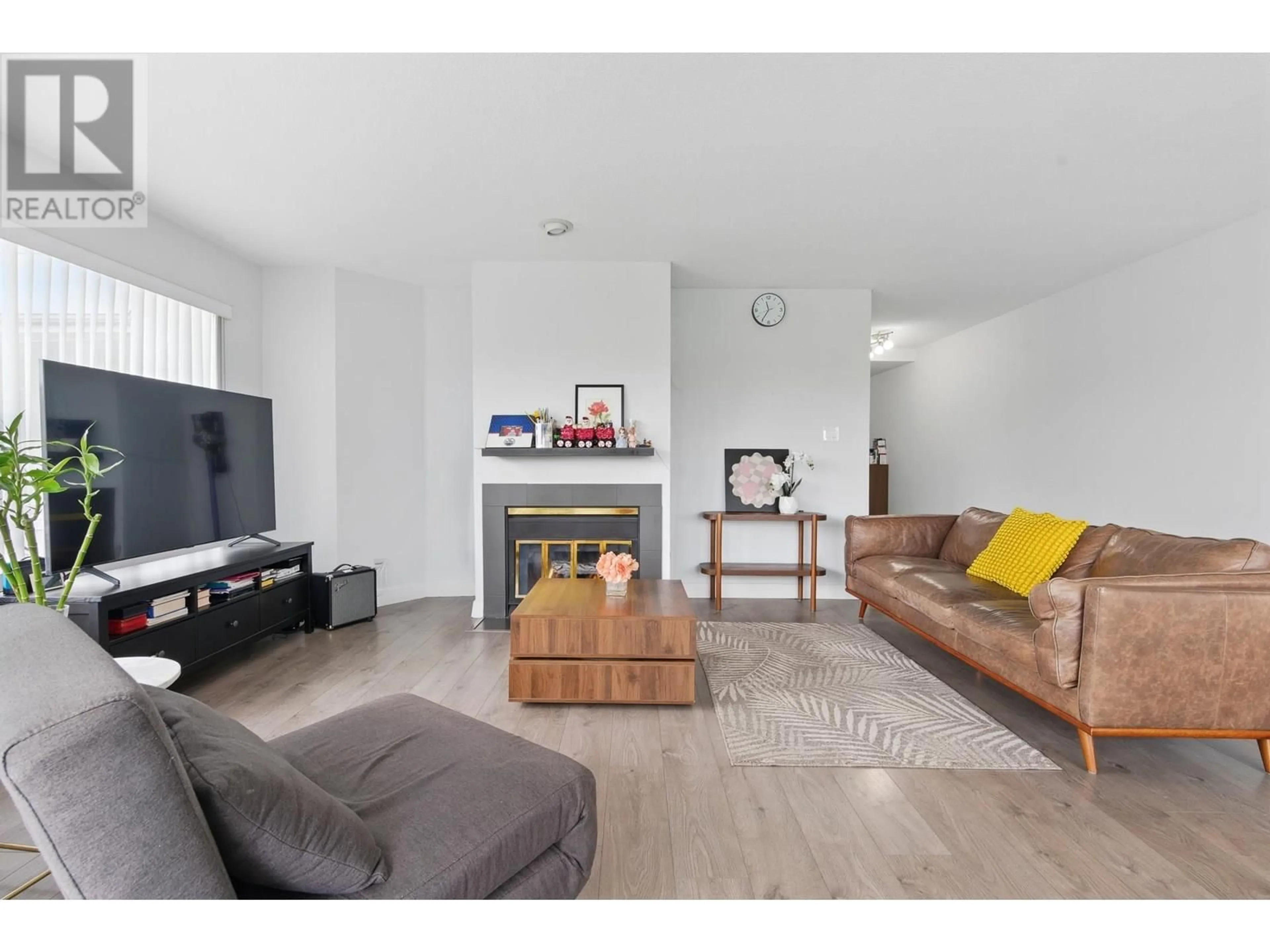Living room with furniture, wood/laminate floor for 104 - 7480 GILBERT ROAD, Richmond British Columbia V7C3W2