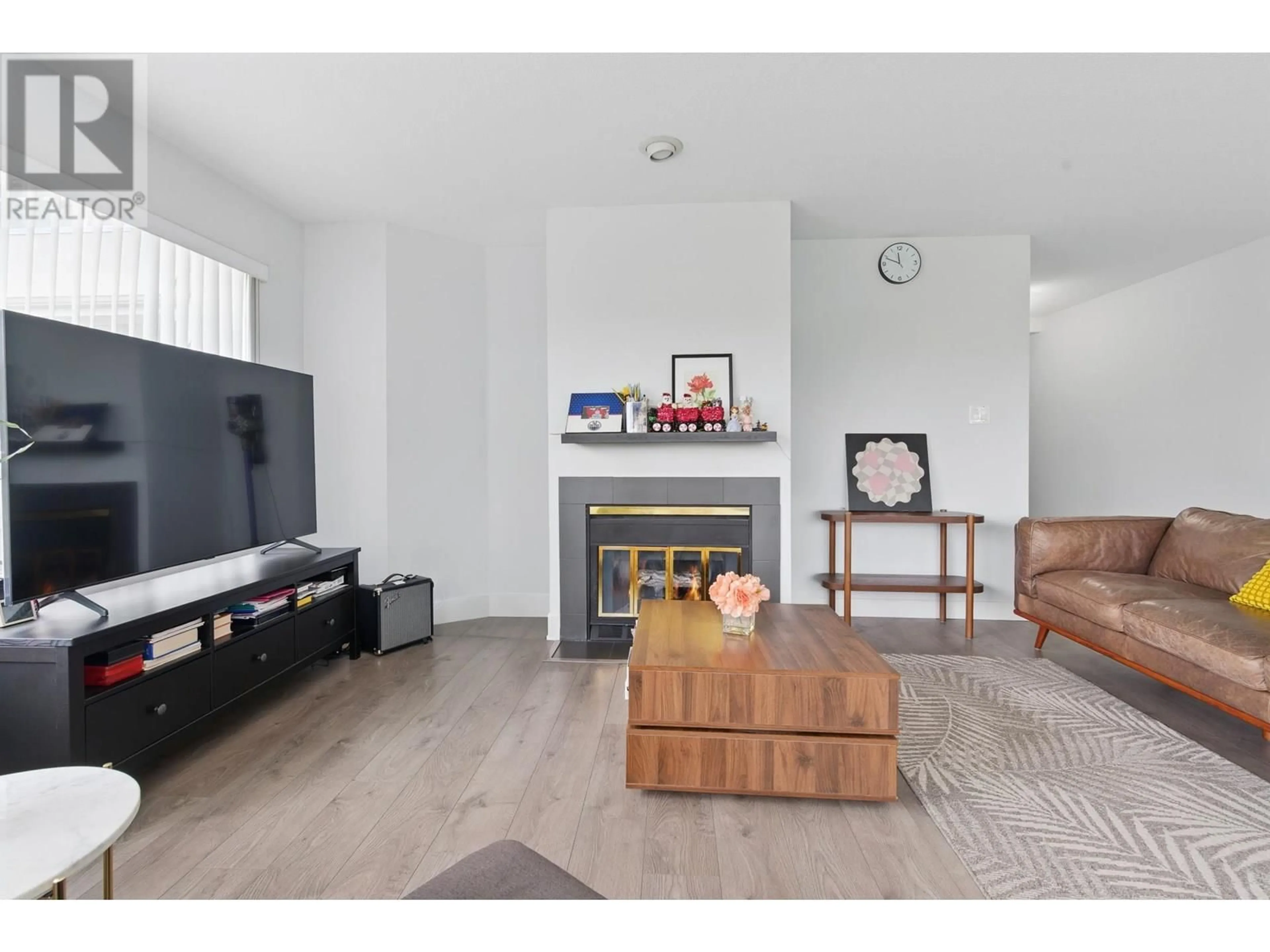 Living room with furniture, wood/laminate floor for 104 - 7480 GILBERT ROAD, Richmond British Columbia V7C3W2