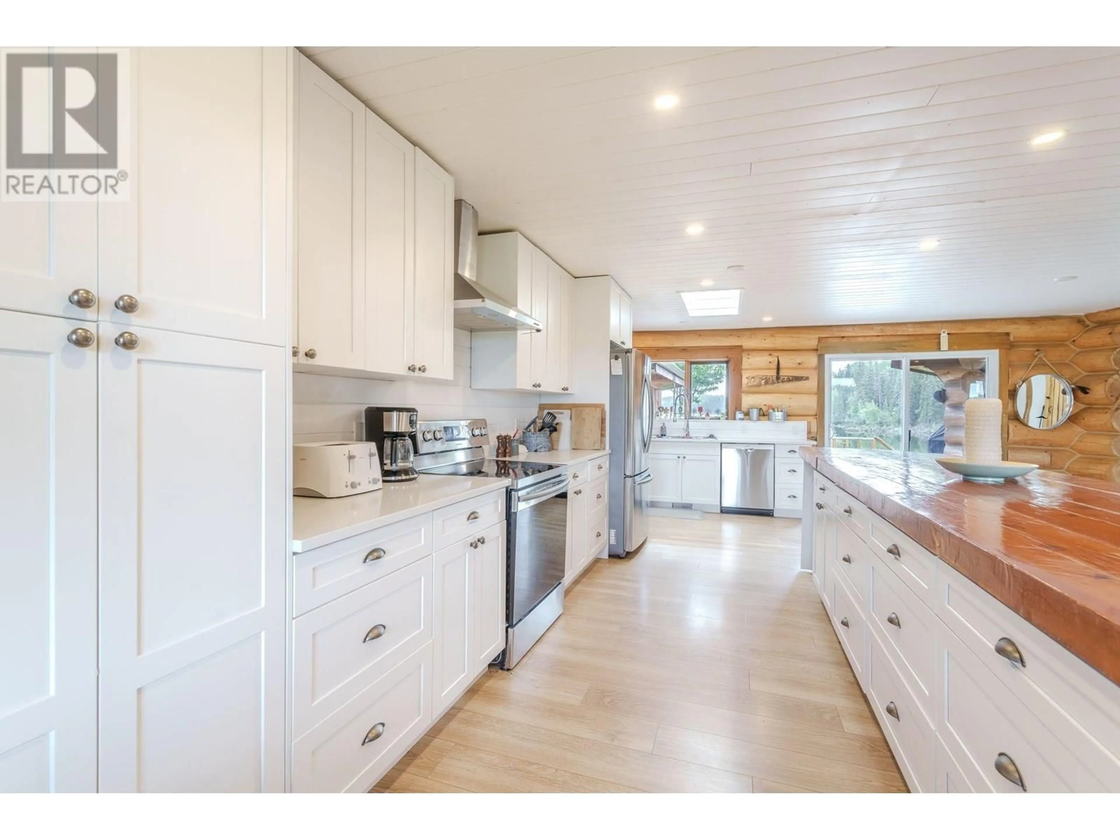 Open concept kitchen, wood/laminate floor for 7806 NORTH BONAPARTE ROAD, Bridge Lake British Columbia V0K1E0