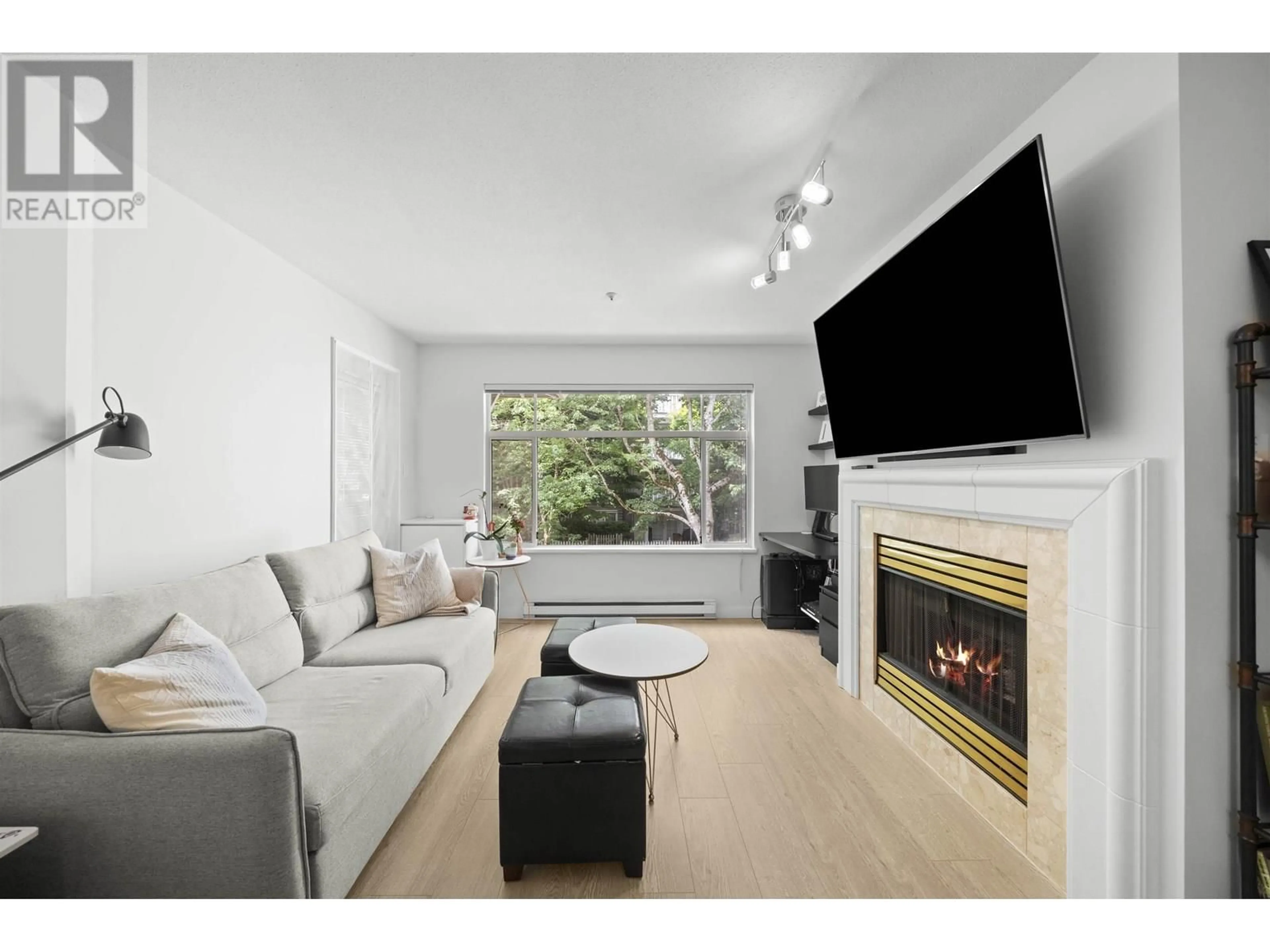 Living room with furniture, wood/laminate floor for 215 - 8180 JONES ROAD, Richmond British Columbia V6Y3Z6