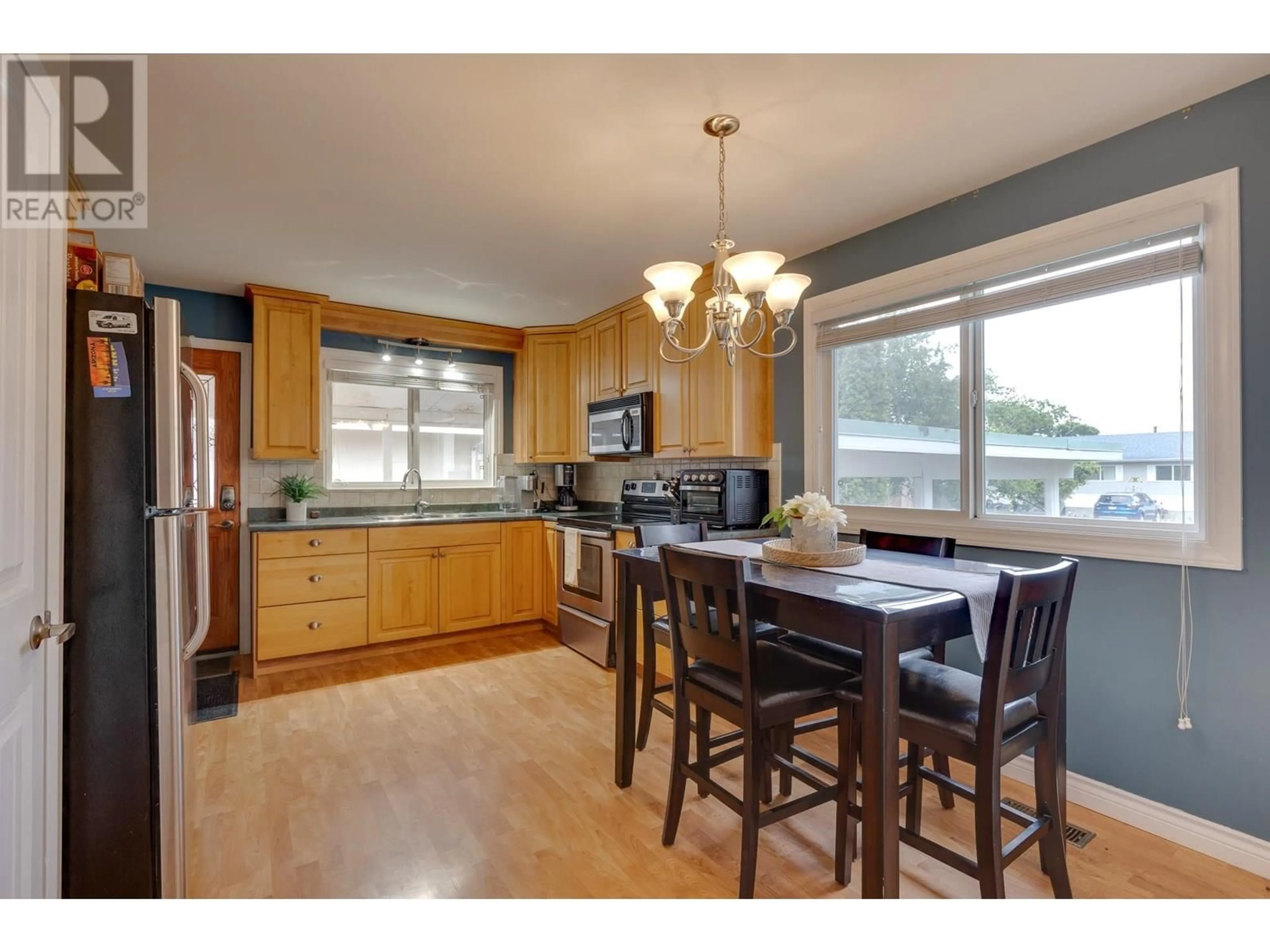 Open concept kitchen, wood/laminate floor for 1302 PARSNIP CRESCENT, Prince George British Columbia V2M4C4