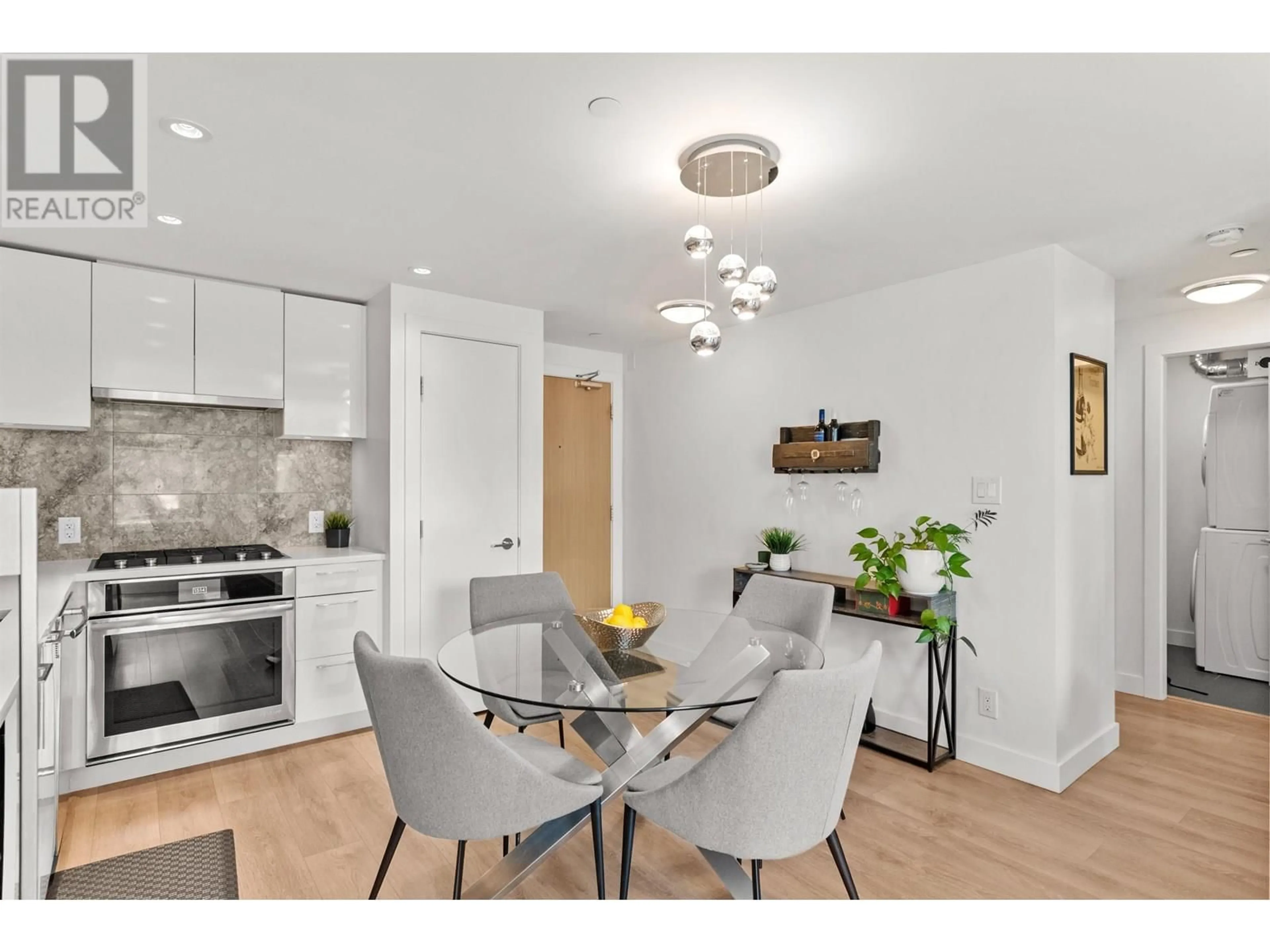 Open concept kitchen, wood/laminate floor for 205 - 3557 SAWMILL CRESCENT, Vancouver British Columbia V5S0E2