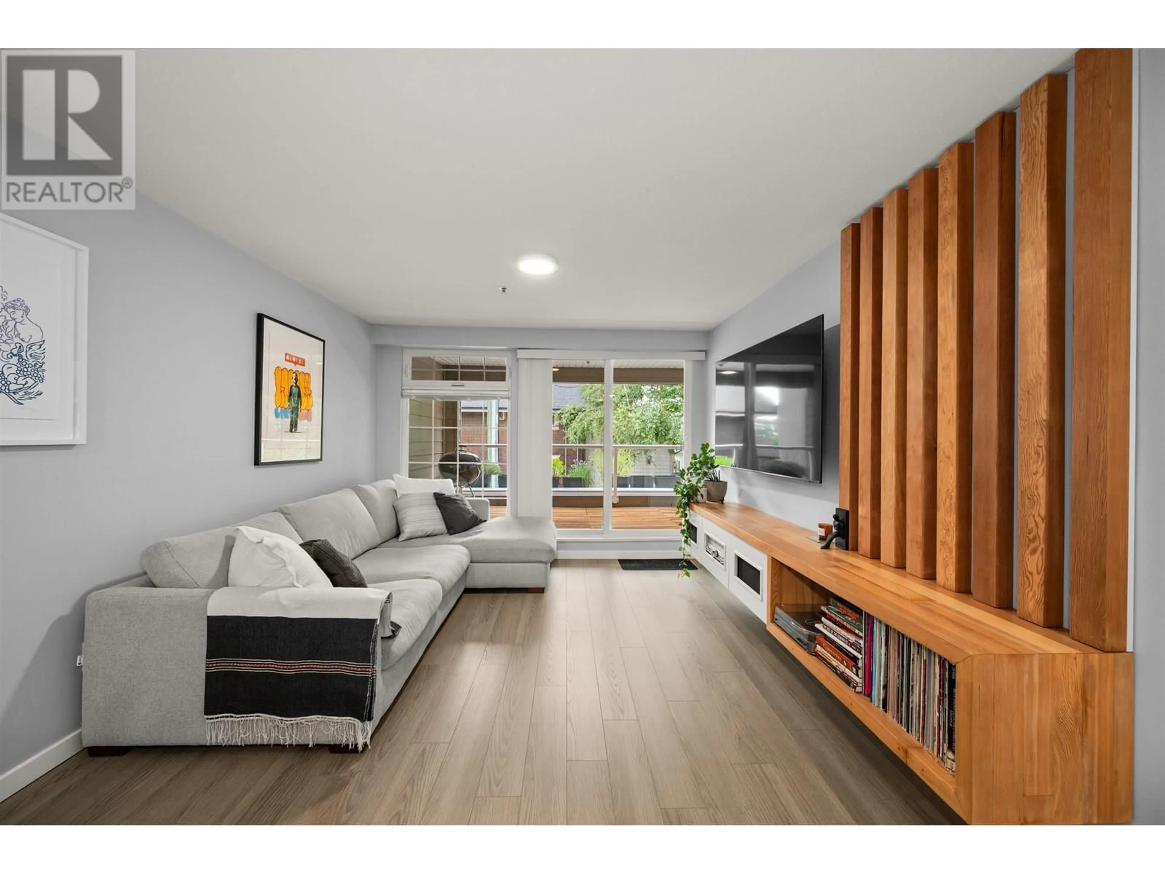 Living room with furniture, wood/laminate floor for 101 - 3981 FRASER STREET, Vancouver British Columbia V5V4E5