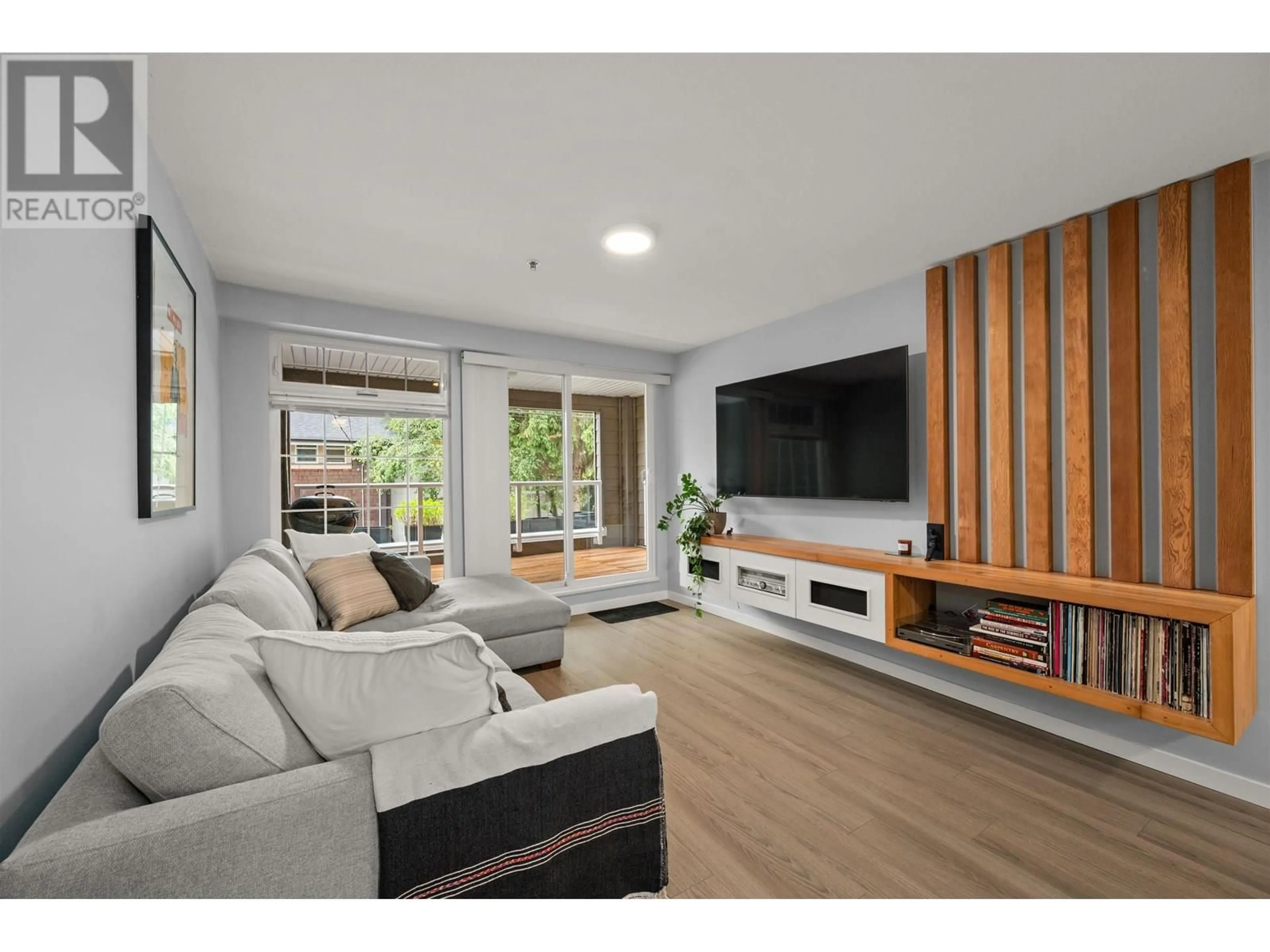 Living room with furniture, wood/laminate floor for 101 - 3981 FRASER STREET, Vancouver British Columbia V5V4E5