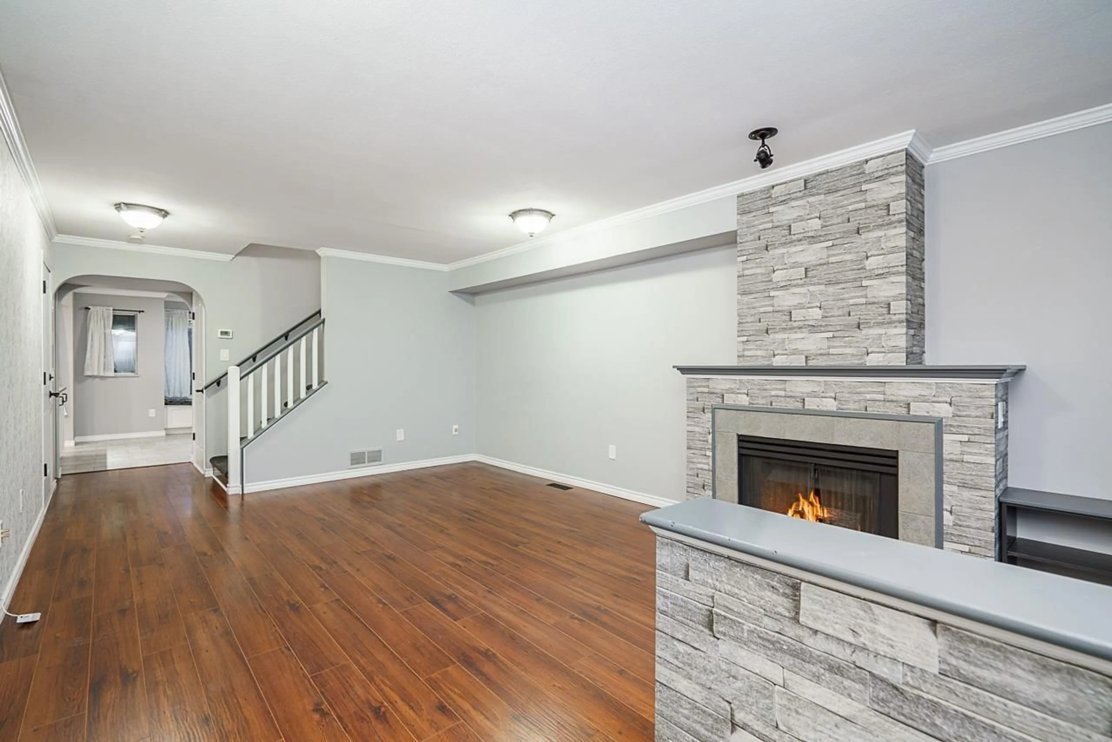 Living room with furniture, wood/laminate floor for 23 - 18883 65, Surrey British Columbia V3S8Y2