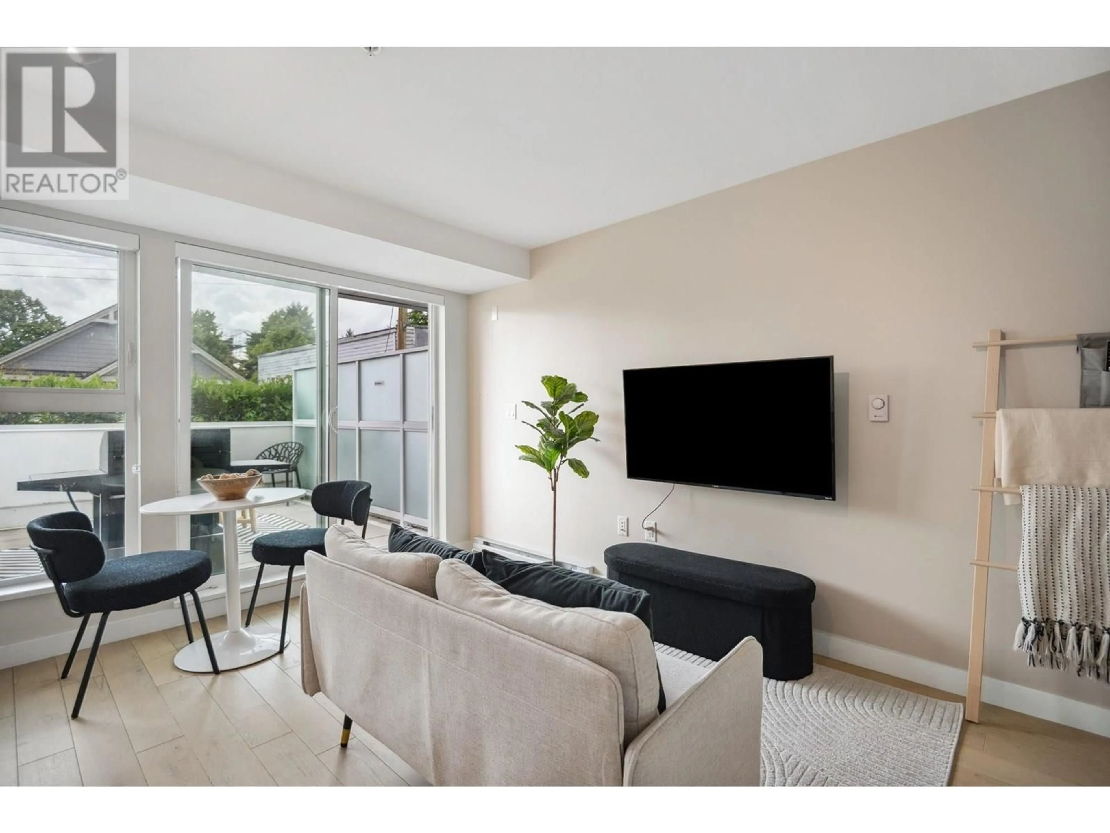 Living room with furniture, unknown for 208 - 2508 FRASER STREET, Vancouver British Columbia V5T3V4