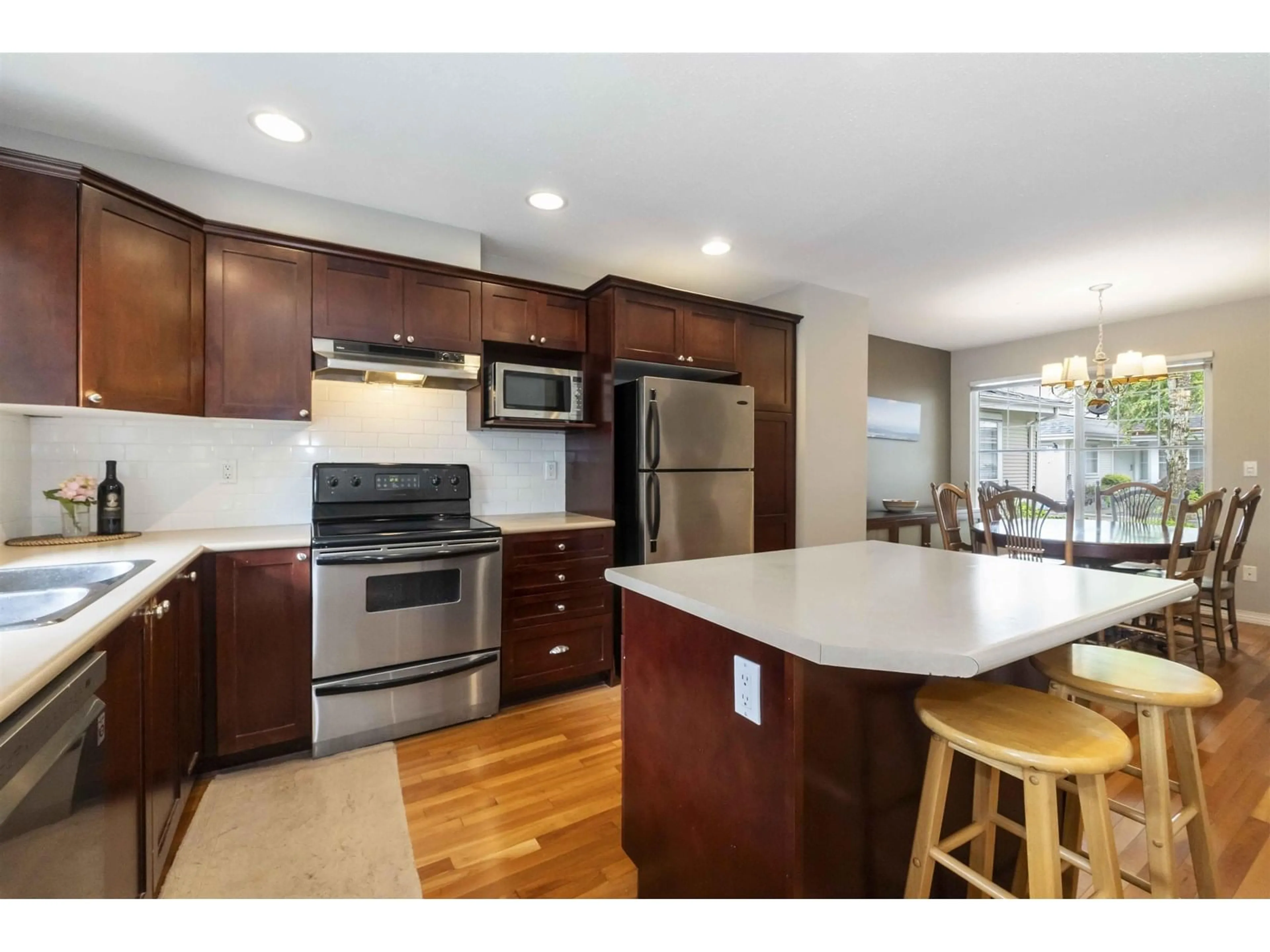 Open concept kitchen, wood/laminate floor for 46 - 17097 64, Surrey British Columbia V3S1Y5