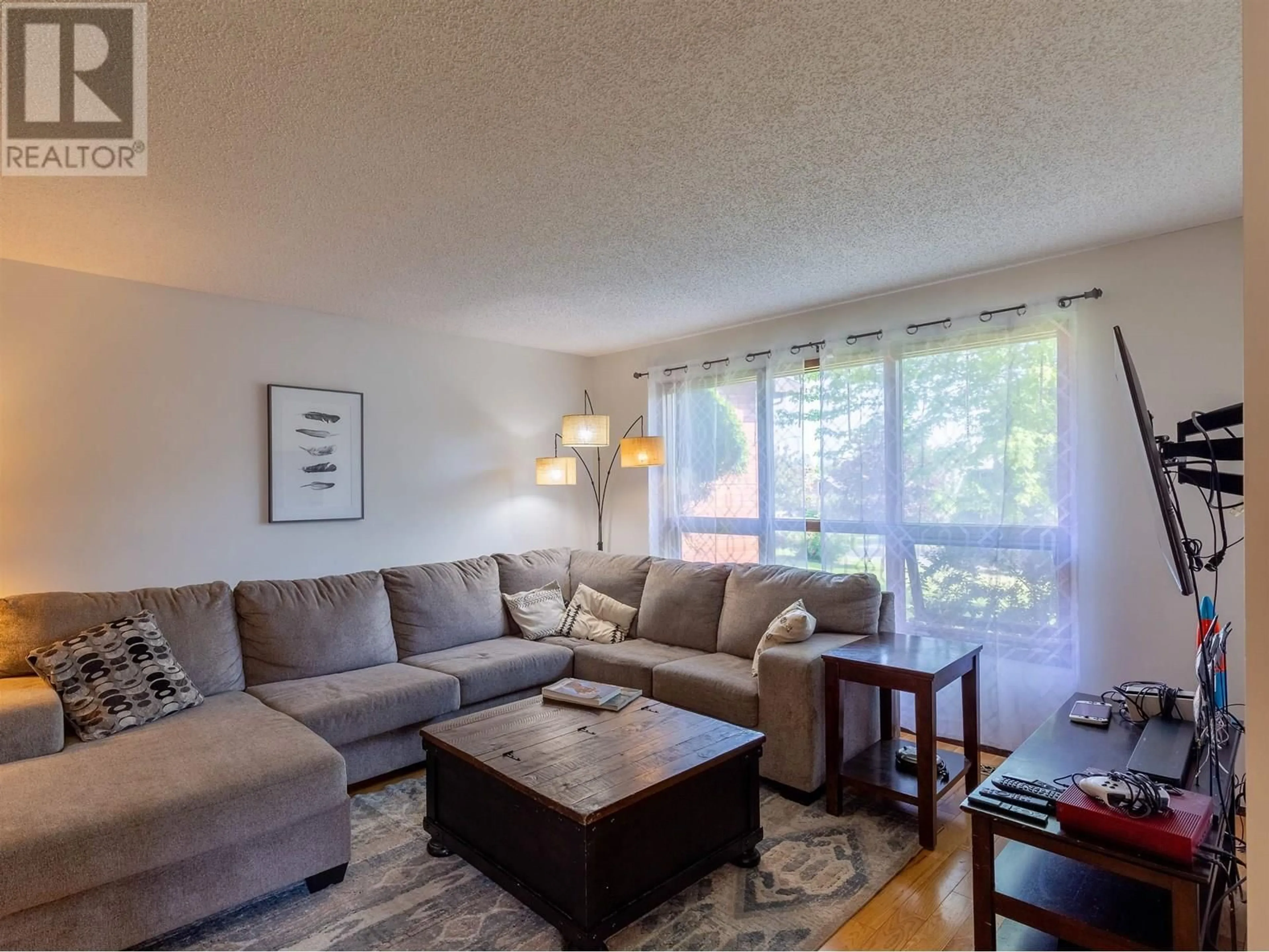 Living room with furniture, wood/laminate floor for 3454 NADINA PLACE, Smithers British Columbia V0J2N0