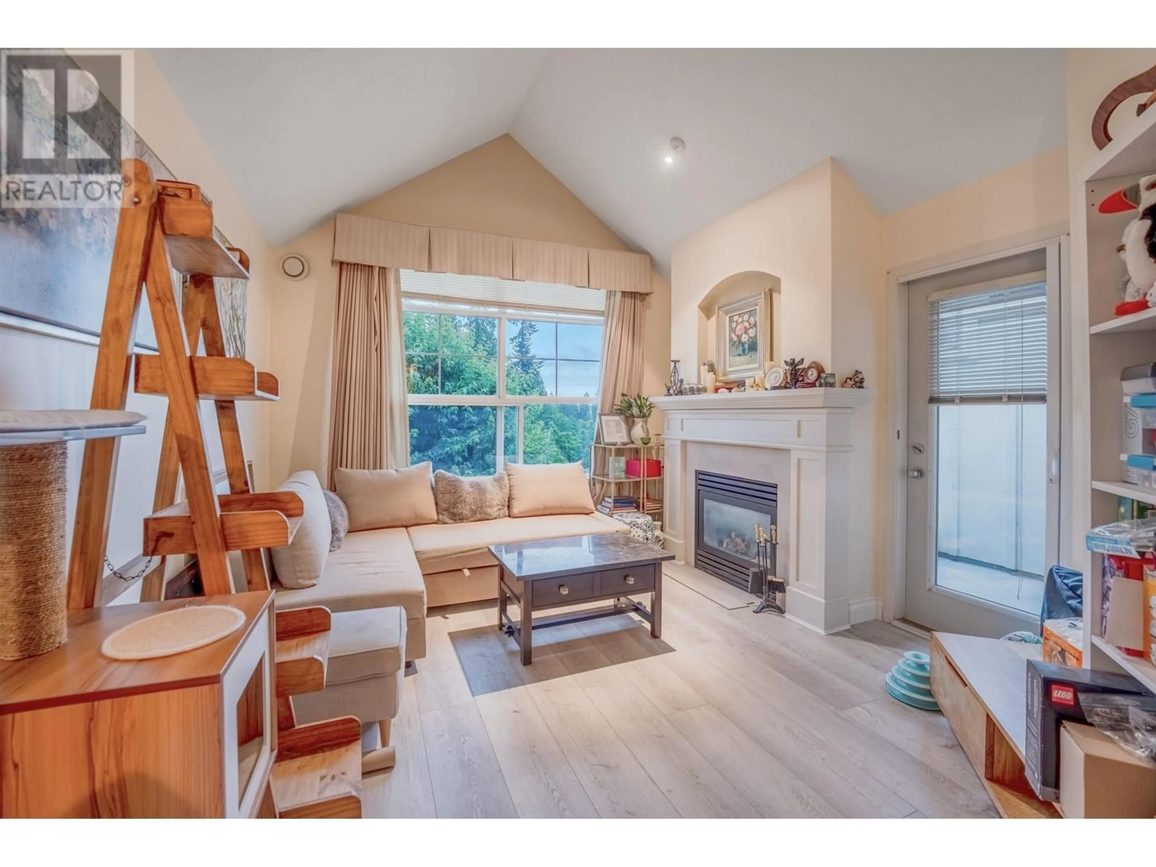 Living room with furniture, wood/laminate floor for 416 - 960 LYNN VALLEY ROAD, North Vancouver British Columbia V7J3V6