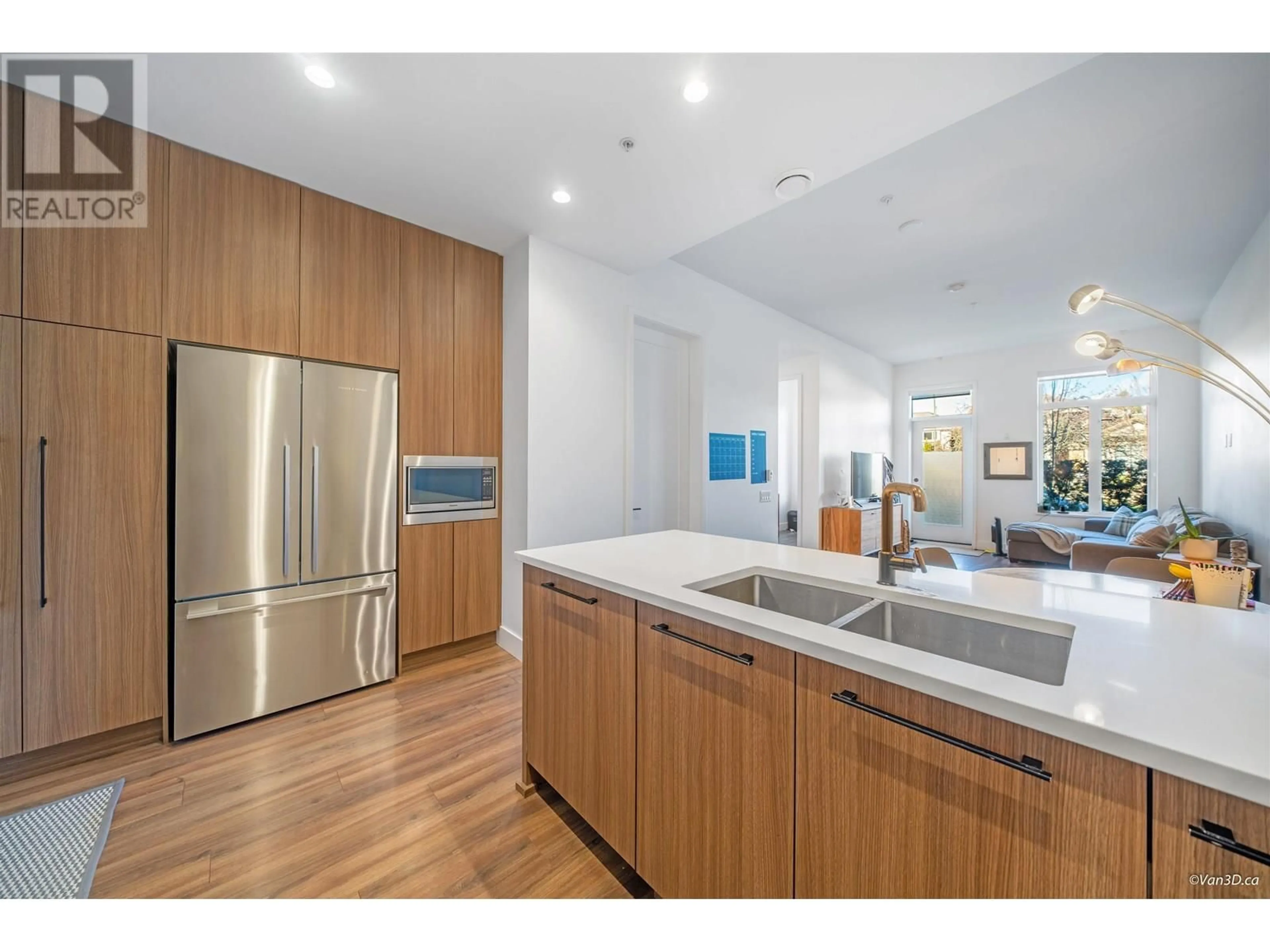 Open concept kitchen, wood/laminate floor for 109 - 288 KING EDWARD AVENUE, Vancouver British Columbia V5Y2J2