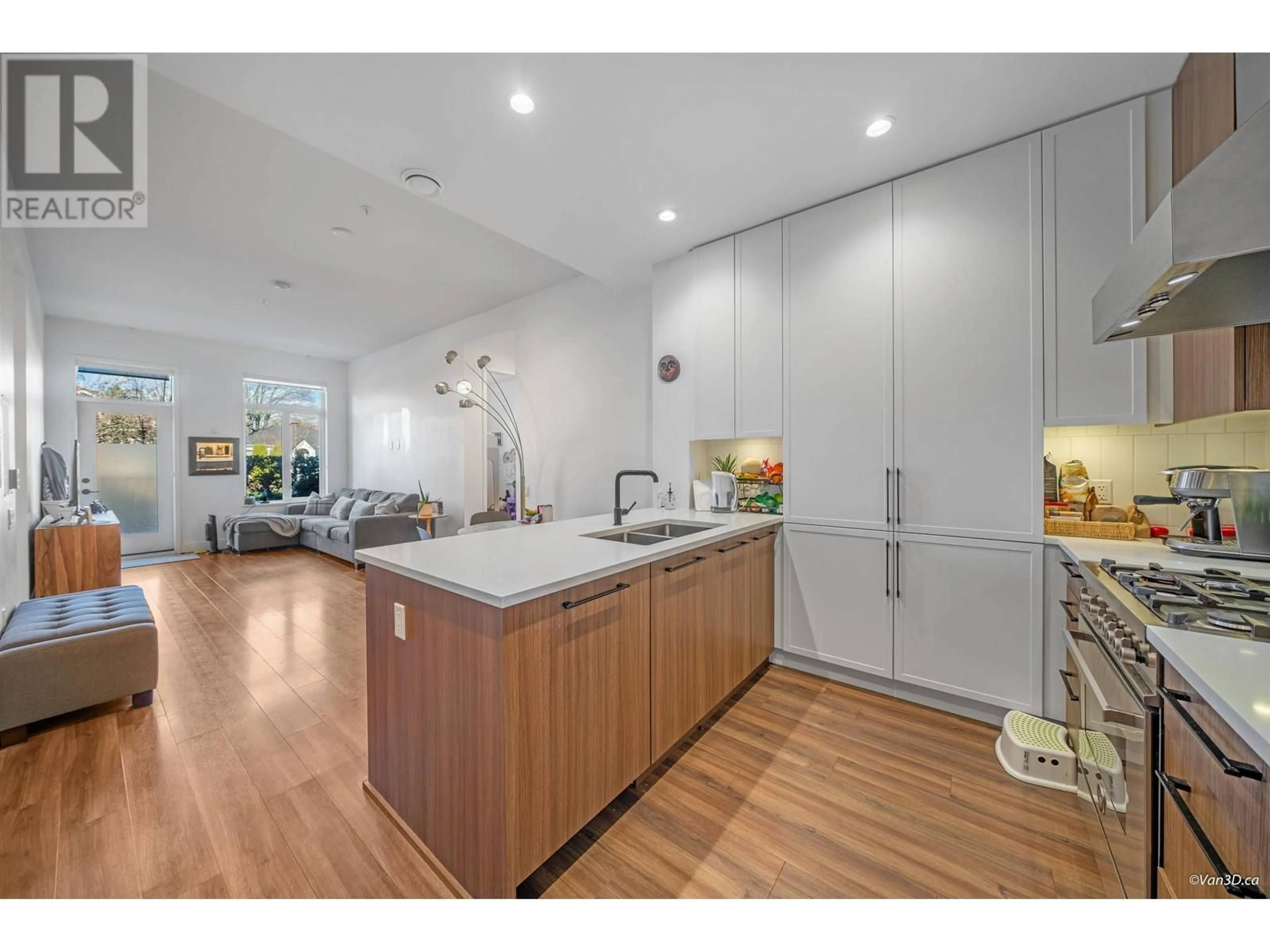 Open concept kitchen, wood/laminate floor for 109 - 288 KING EDWARD AVENUE, Vancouver British Columbia V5Y2J2