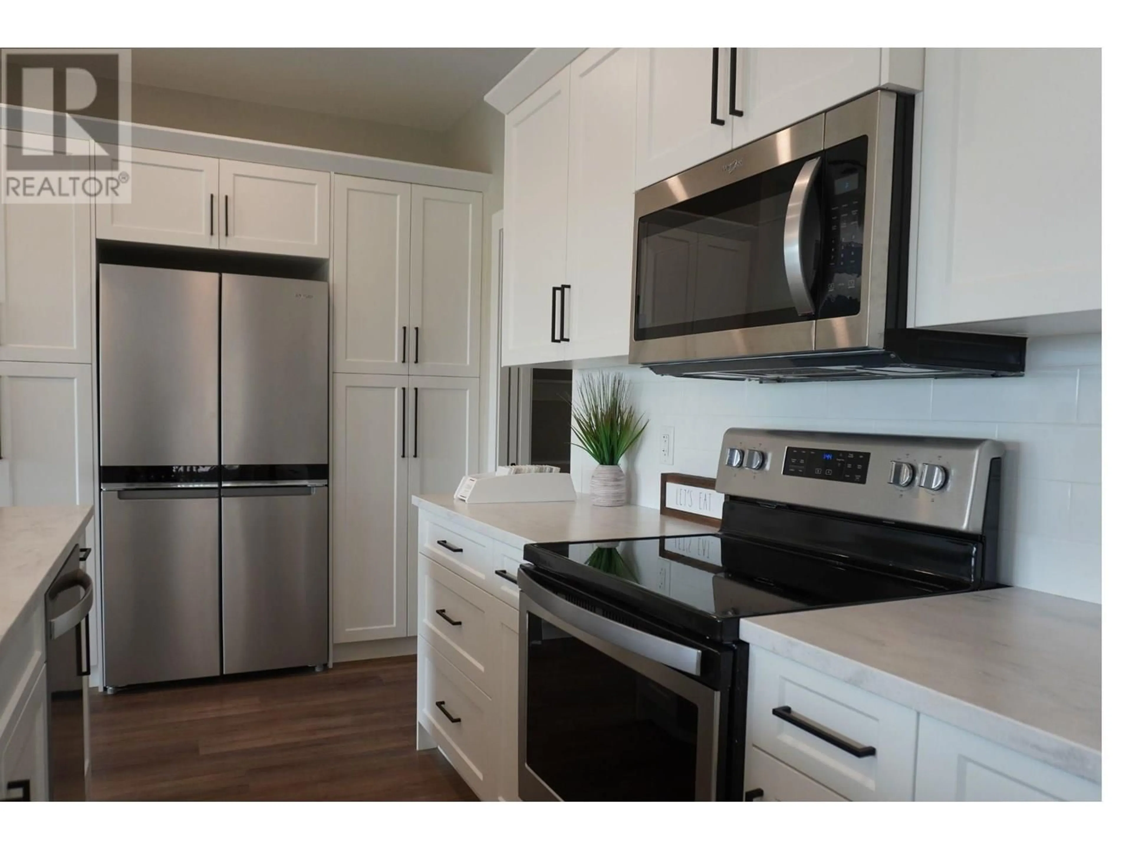 Open concept kitchen, wood/laminate floor for 307 - 9800 SINTICH ROAD, Prince George British Columbia V2N6E2