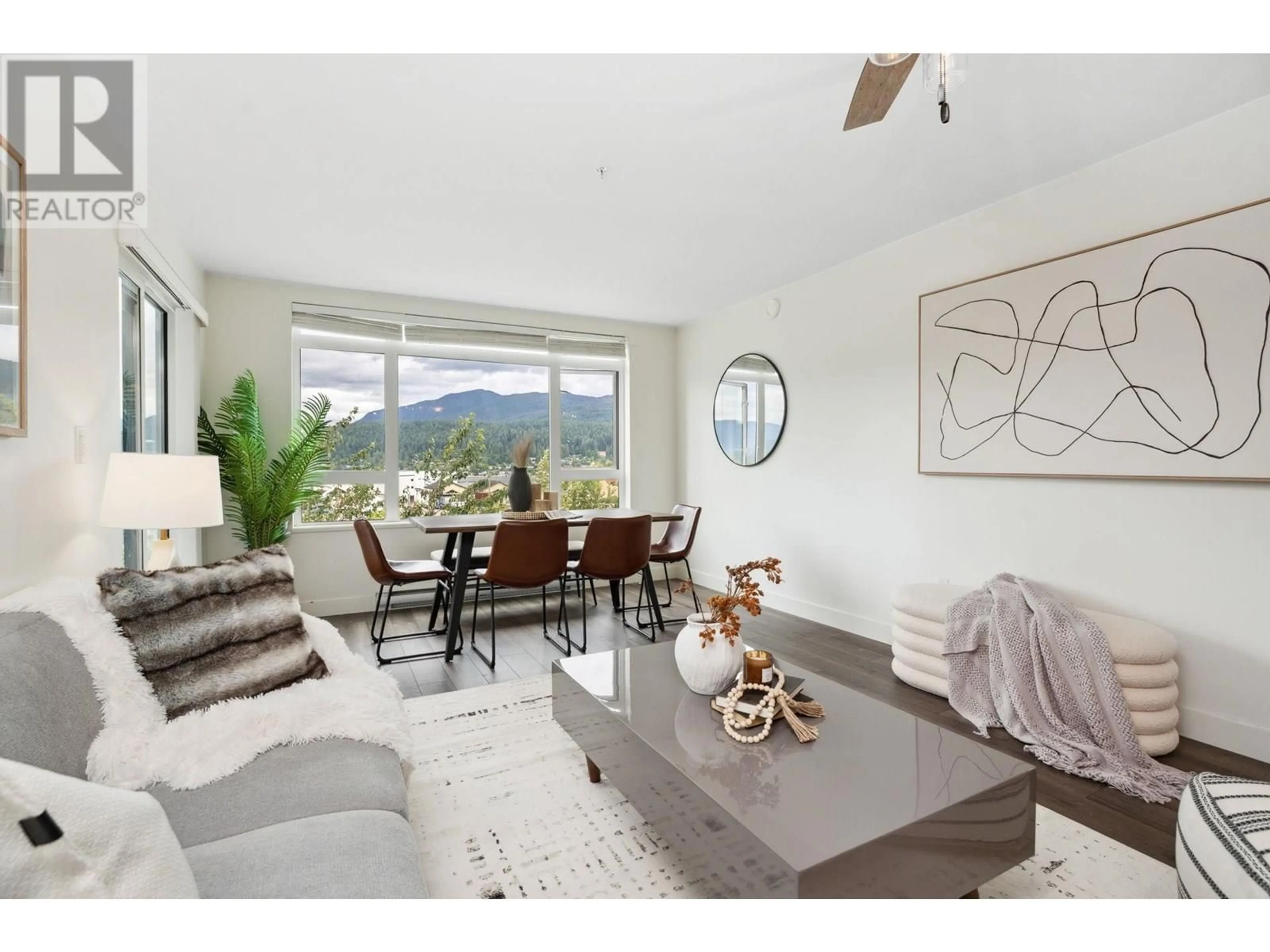 Living room with furniture, wood/laminate floor for 312 - 2525 CLARKE STREET, Port Moody British Columbia V3H0J3
