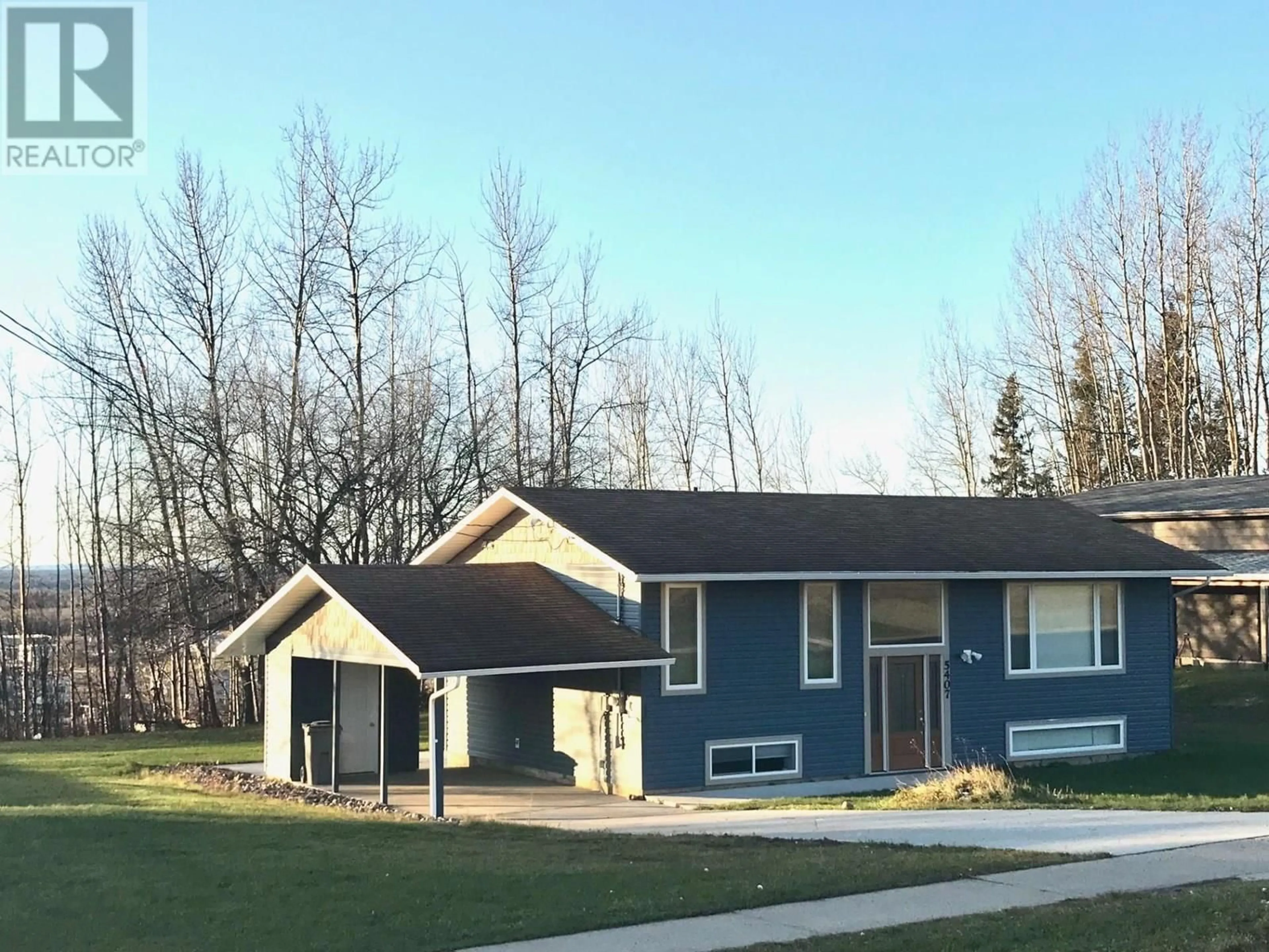 Home with vinyl exterior material, street for 5407 54 AVENUE, Fort Nelson British Columbia V0C1R0