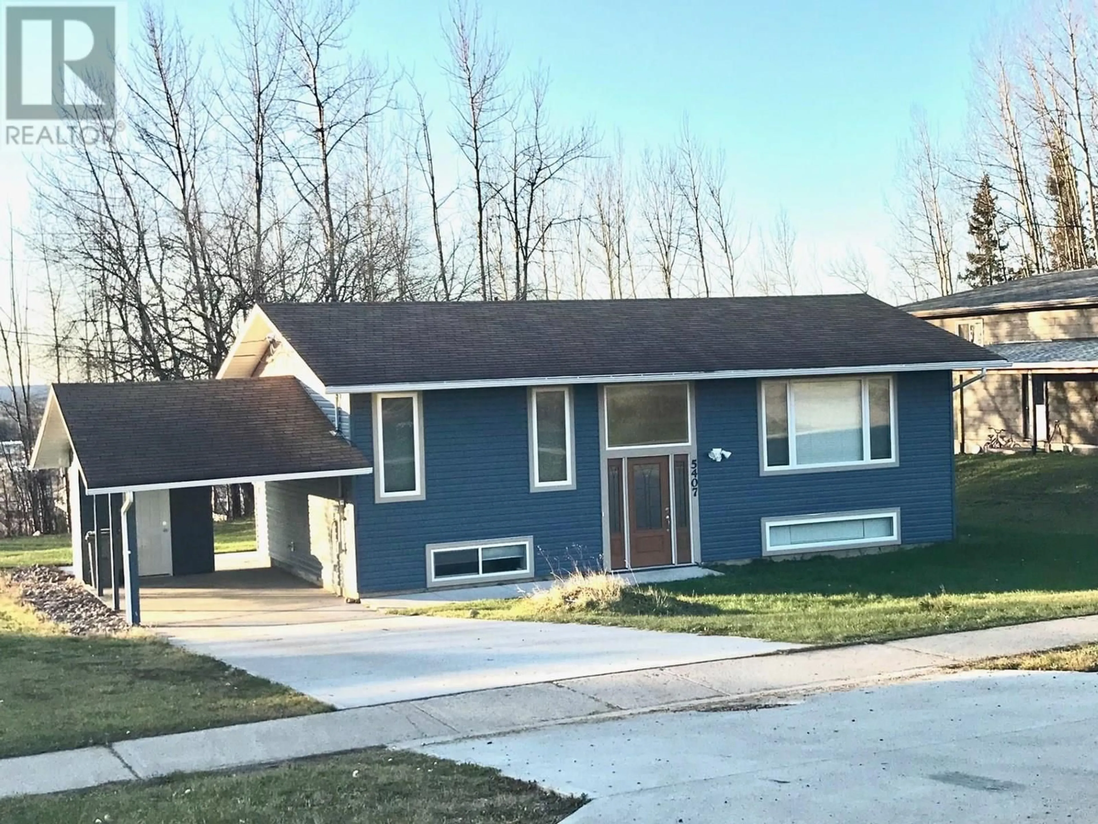 Home with vinyl exterior material, street for 5407 54 AVENUE, Fort Nelson British Columbia V0C1R0