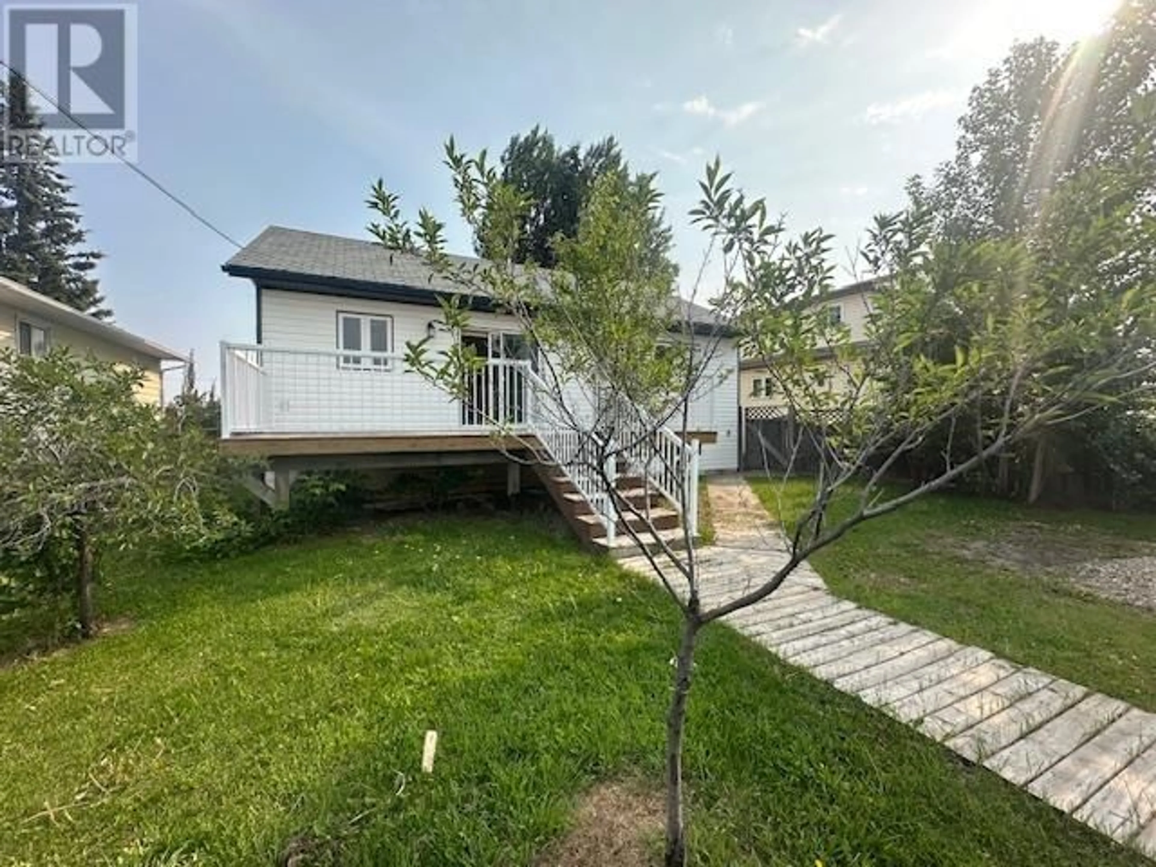 A pic from outside/outdoor area/front of a property/back of a property/a pic from drone, street for 8216 94 AVENUE, Fort St. John British Columbia V1J1E8