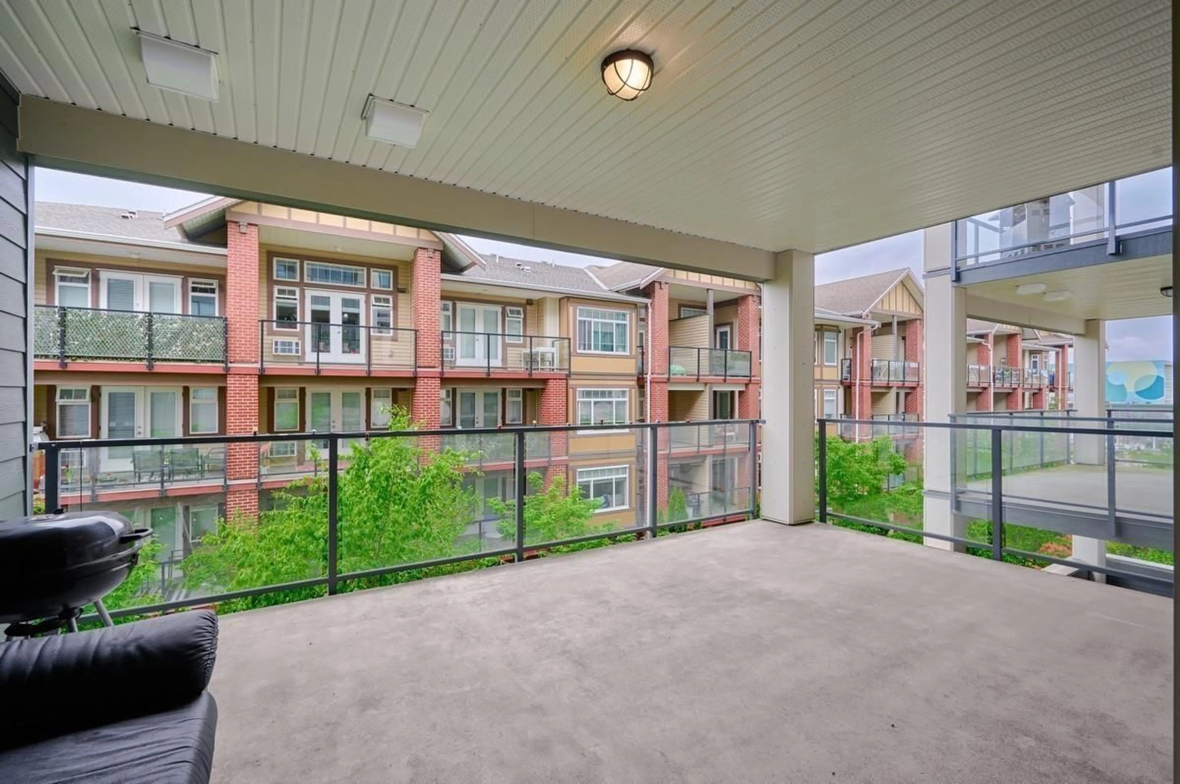 Patio, city buildings view from balcony for 313 - 5638 201A, Langley British Columbia V3A0L8