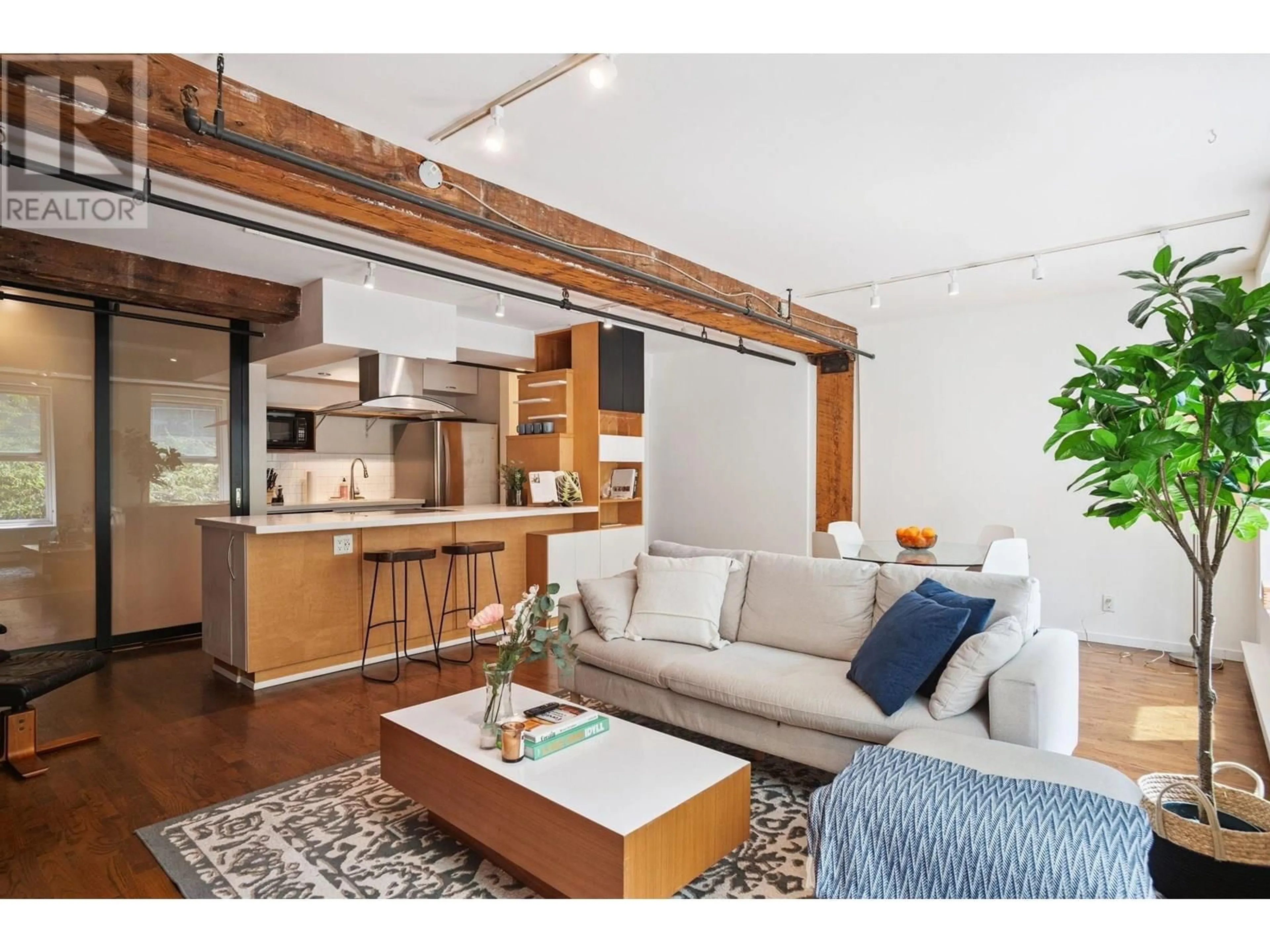 Living room with furniture, wood/laminate floor for 203 - 150 ALEXANDER STREET, Vancouver British Columbia V6A1B5
